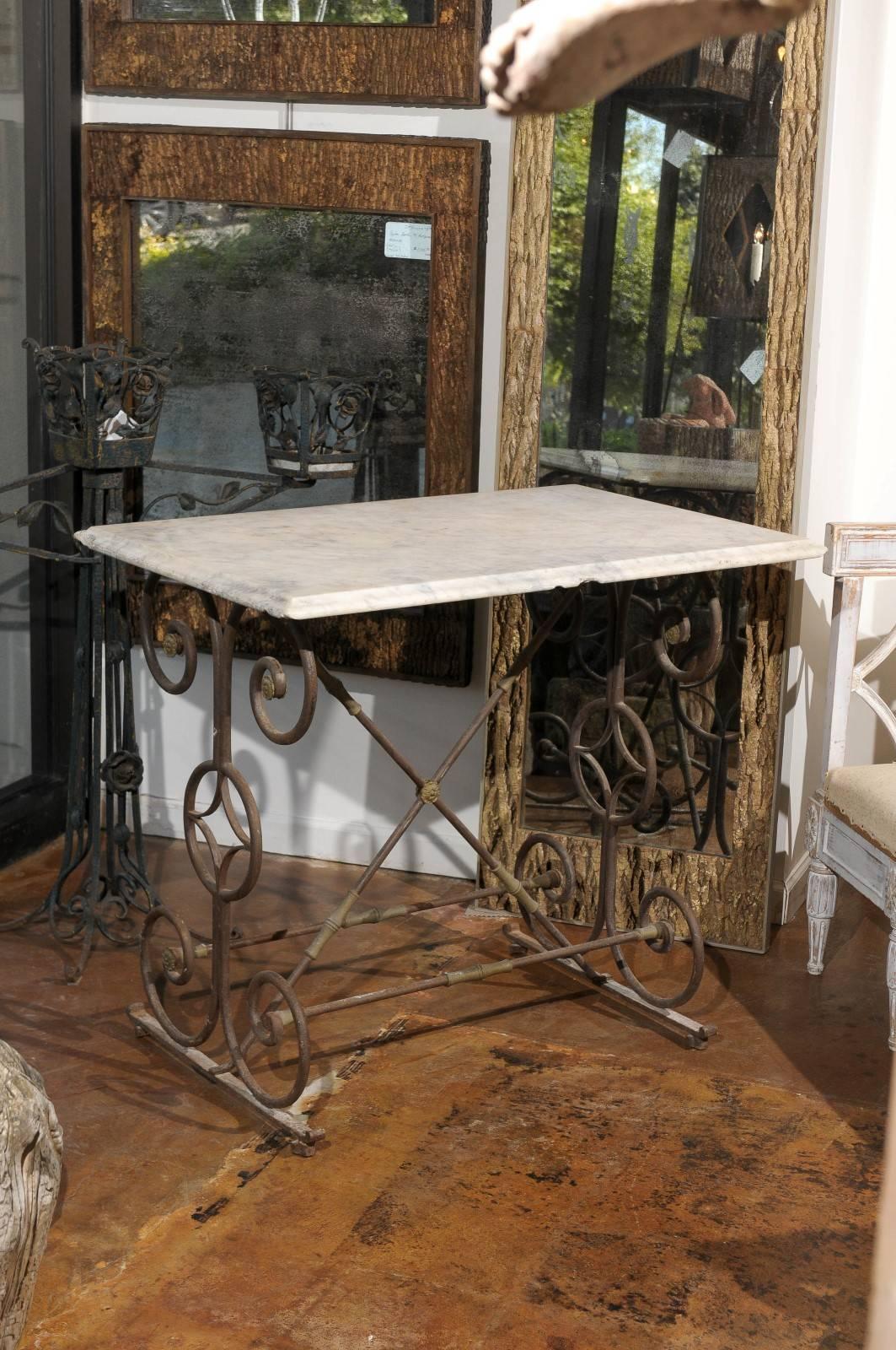 Early 19th century French iron butcher table with marble top, with scrolling iron legs.