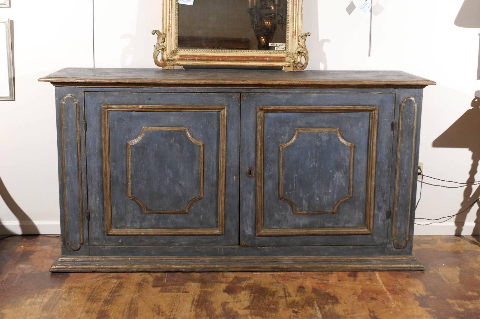 Mid-19th century Italian poplar buffet, the blue and gilt painted all-over top surmounting a double door cabinet opening to storage raised on a conforming plinth, Florence.