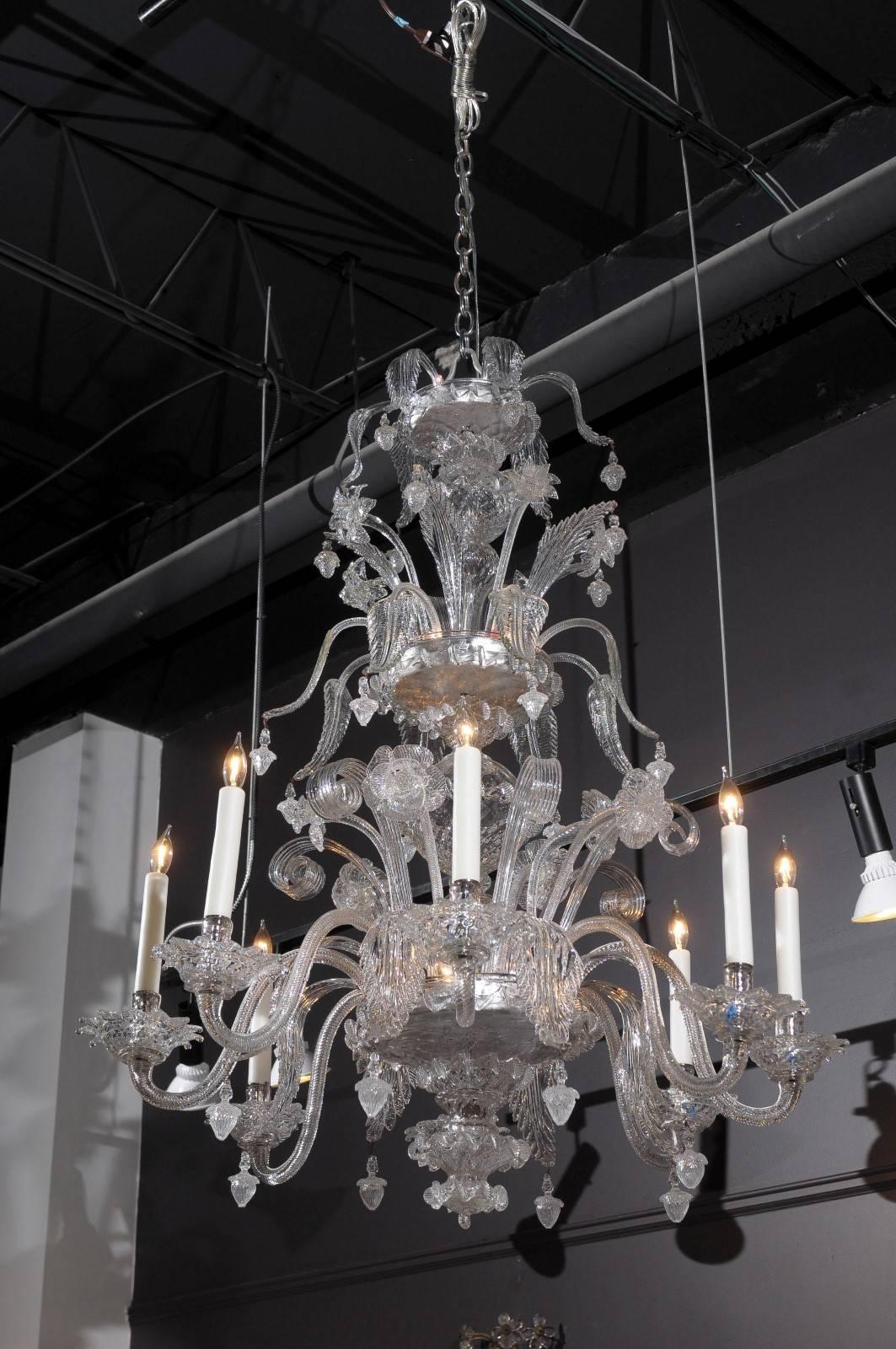 Early 1800s Murano eight-light chandelier, with two rows of sprouting floral and leaf crystal swags above a central support with eight C-form scrolling arms each supporting a light with descending leaf form arms in between, ending in a similar form