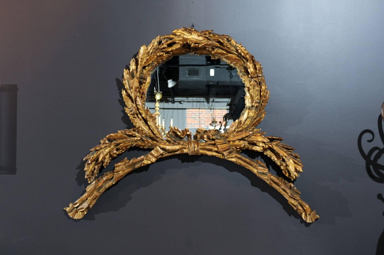 Pair of Italian gilt laurel wreath mirrors, circa 1800.