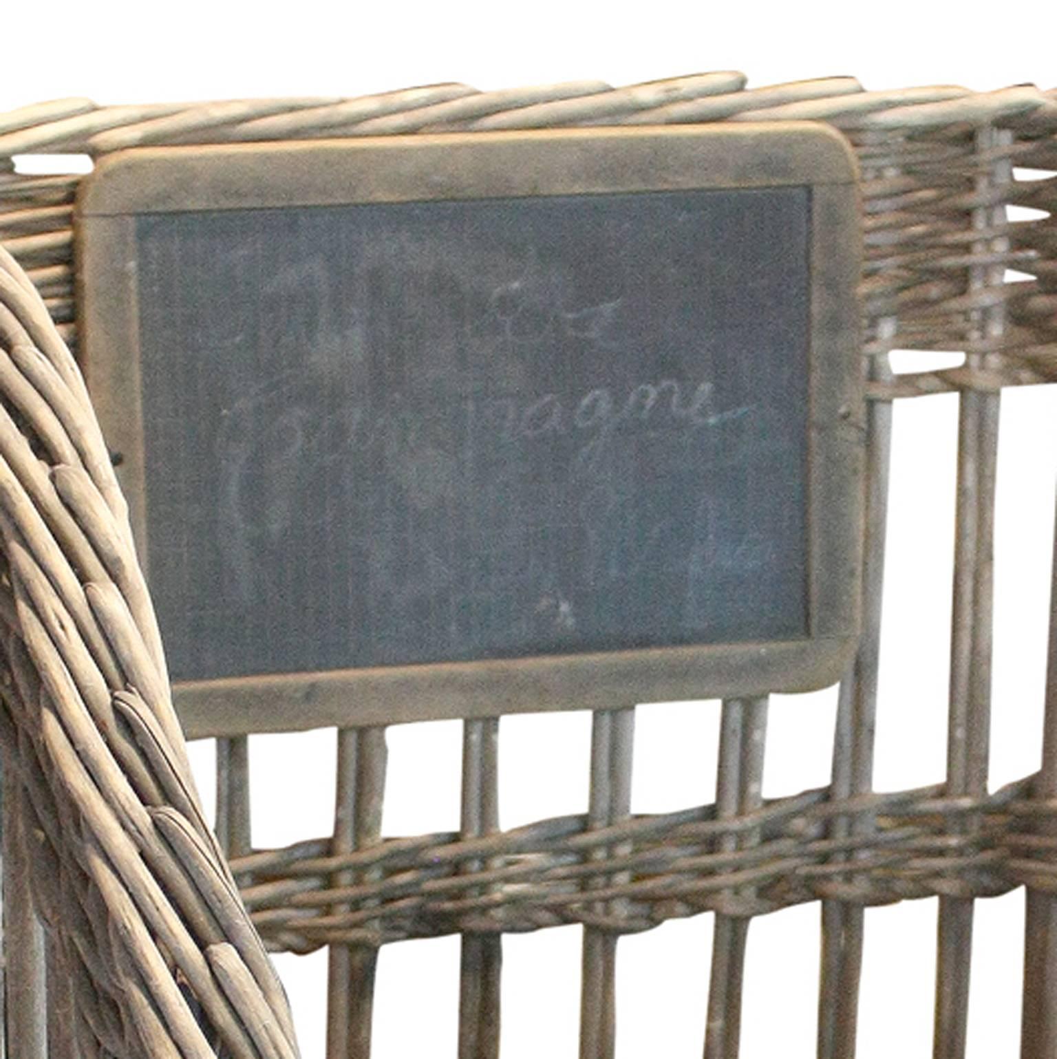 This French large size wicker baguette basket from the 19th century is the perfect object to decorate your home. Purchased from a French baker, the basket still features its chalk board, on which one can make out the faint text: Pain de Campagne.