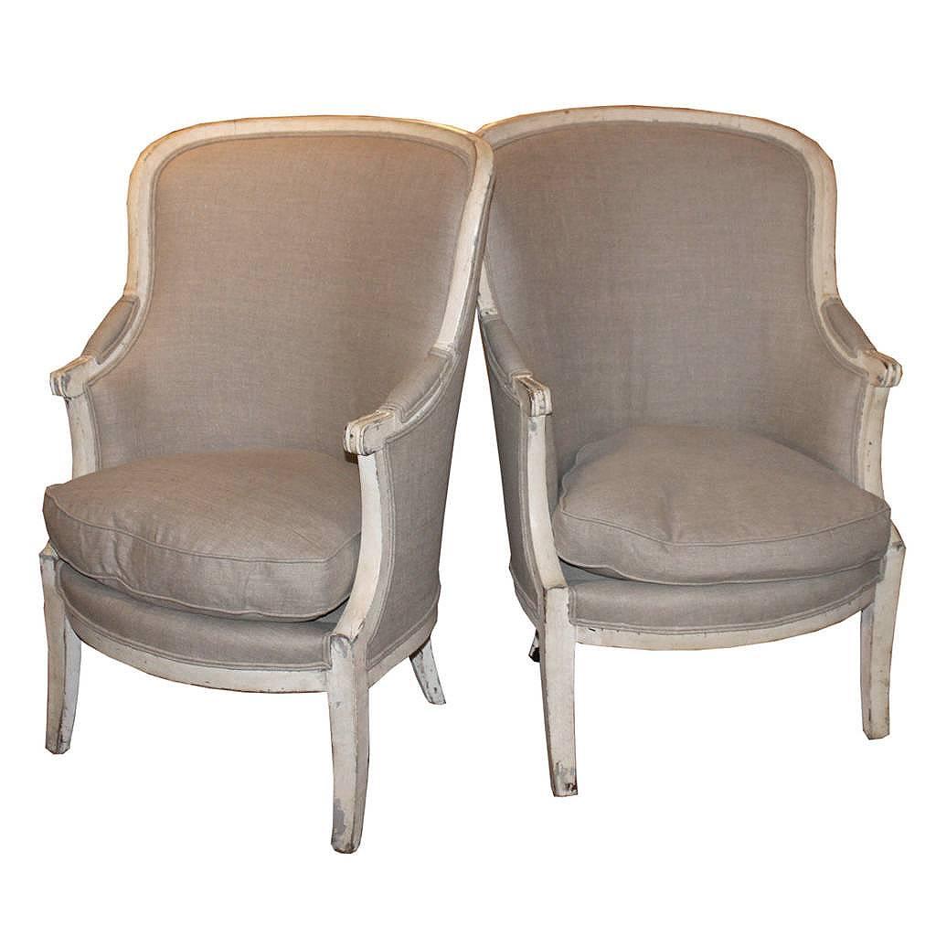 Pair of French 19th Century Barrel Back Upholstered Wing Chairs with Saber Legs