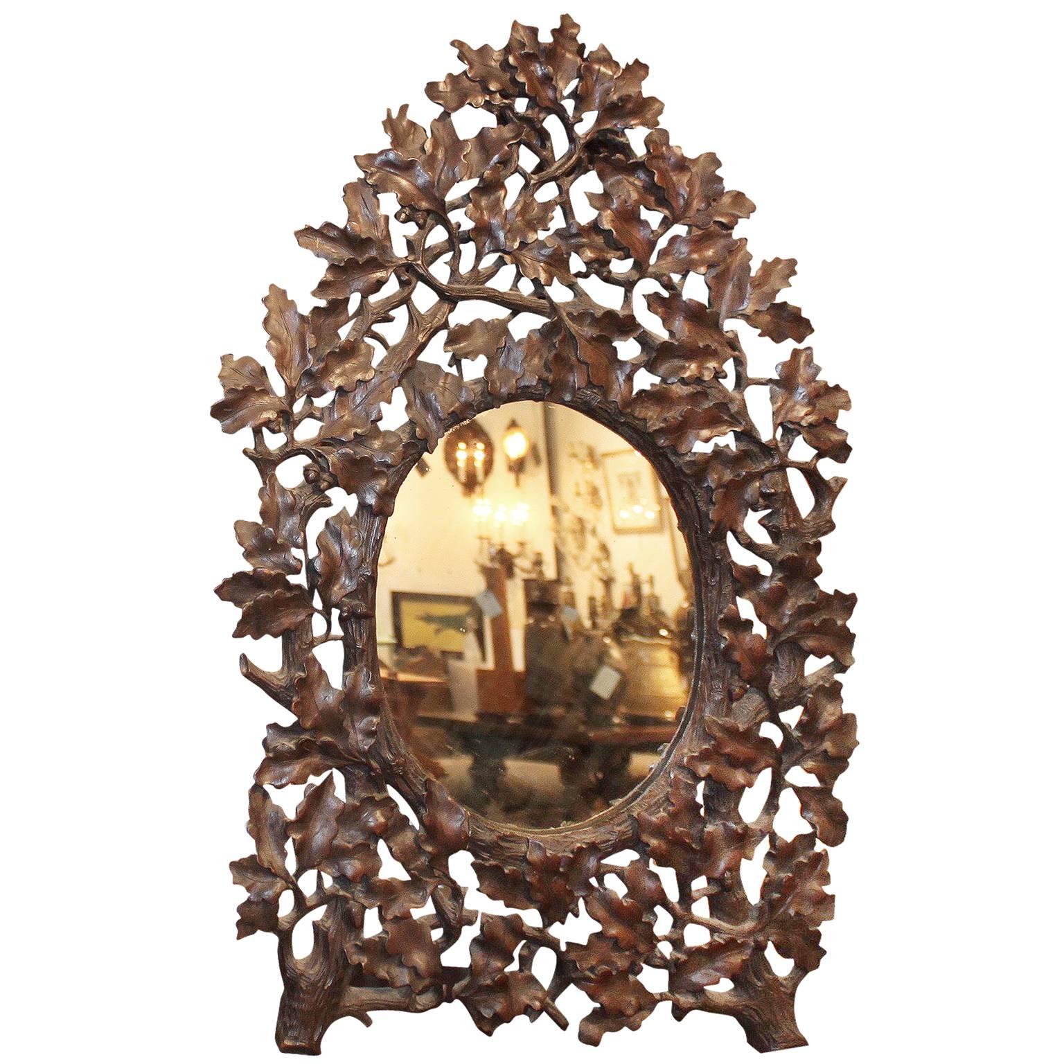 French Black Forest 19th Century Oak Leaves Carved Mirror with Oval Glass