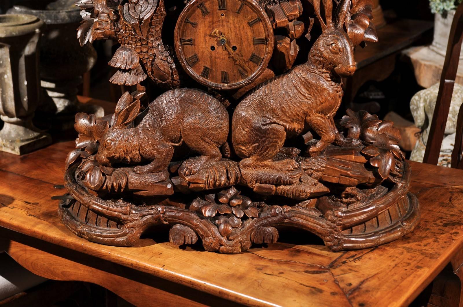 Black Forest Swiss Hand-Carved Wooden Musical Clock with Hound and Hare In Good Condition In Atlanta, GA