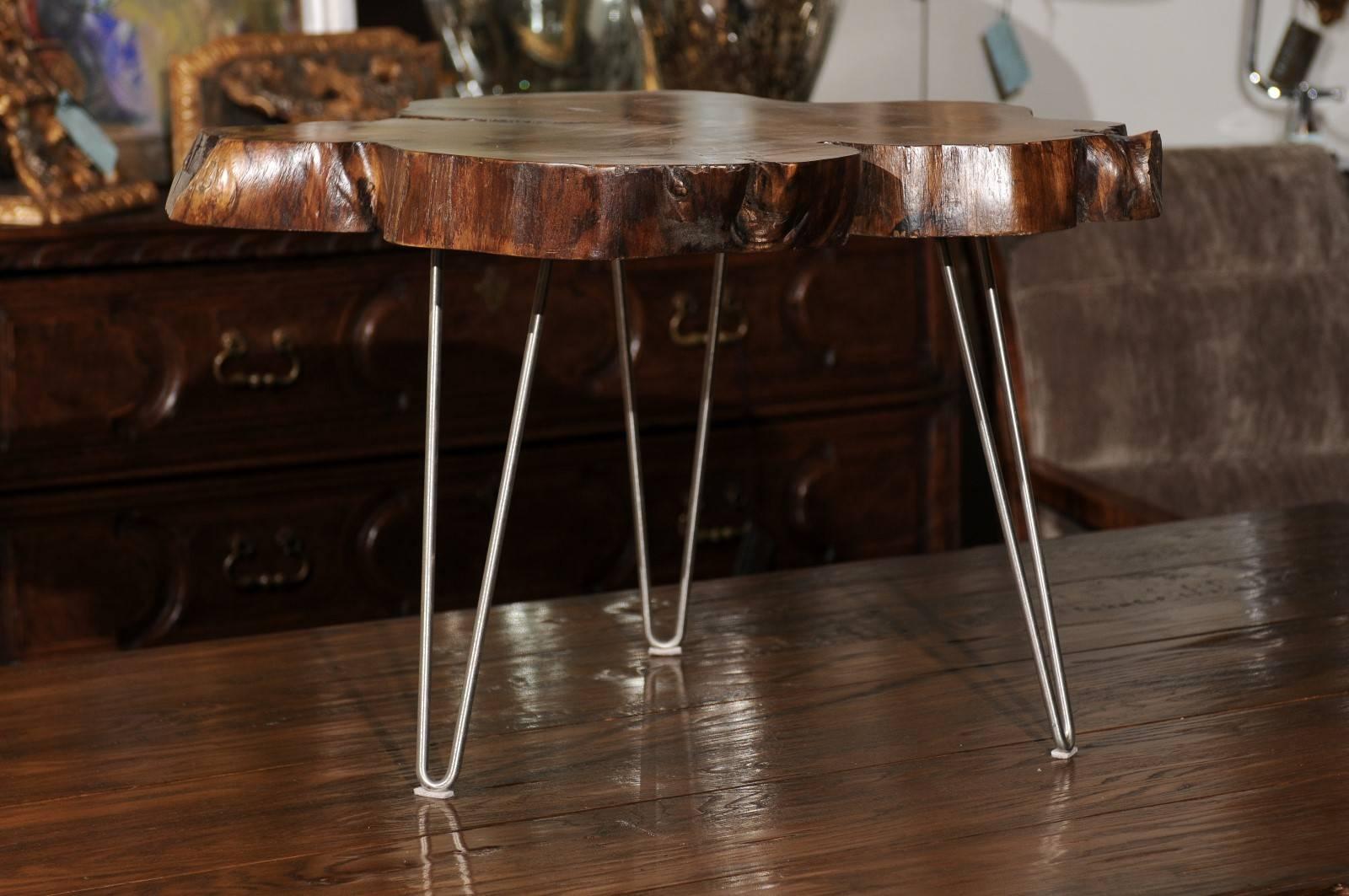 An American custom-made cocktail table with hairpin legs. We currently have three tables available, priced and sold individually. This contemporary cocktail table was made in the US from a magnolia tree. The beautifully grained slab is raised on