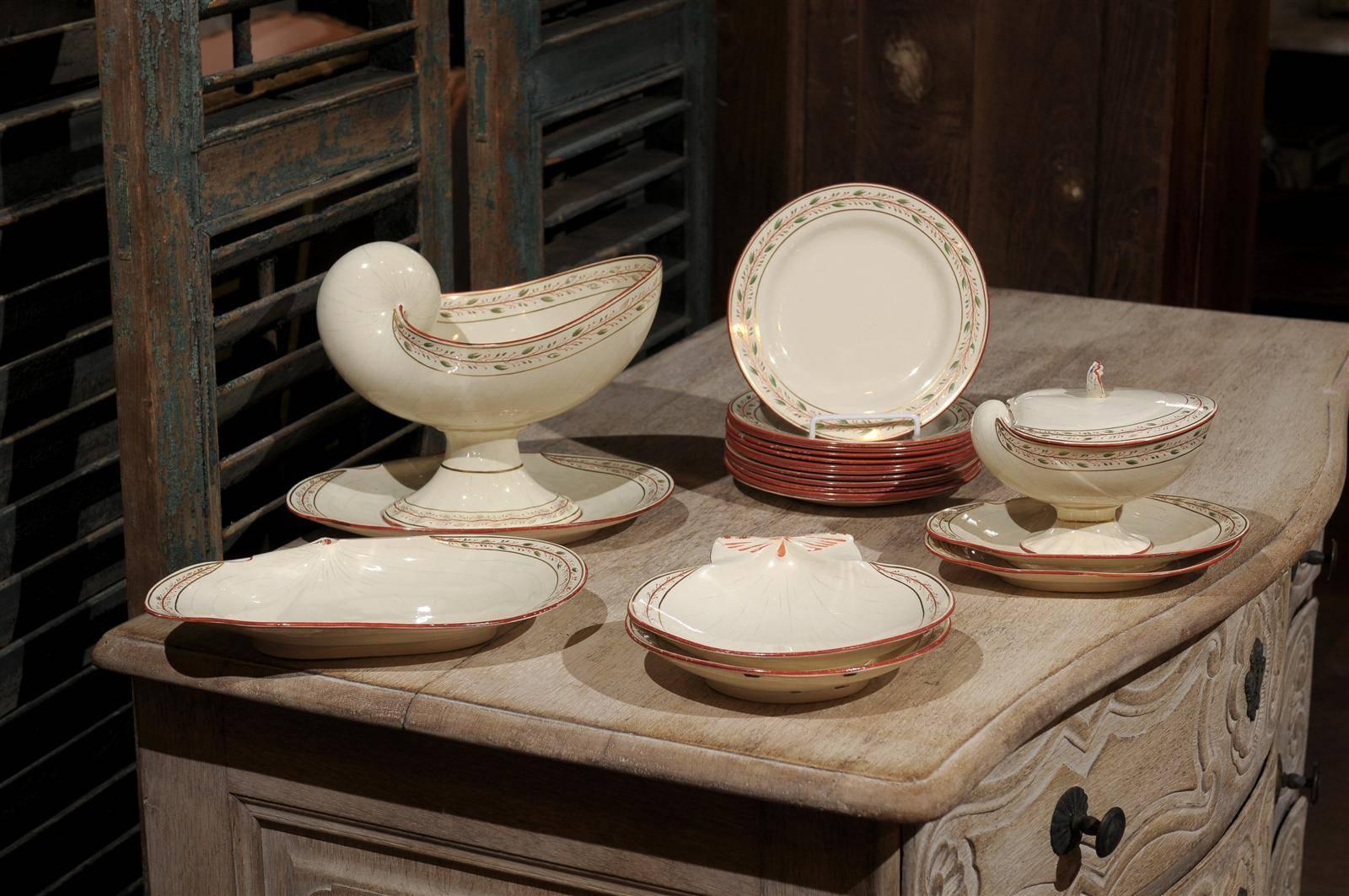 Early 19th century 20-piece wedgwood creamware seashell and seaweed set, includes: Two shell-form plates, four small clam shell platters (two larger than the others), one covered gravy boat, one large serving piece and 12 small dinner plates, maker
