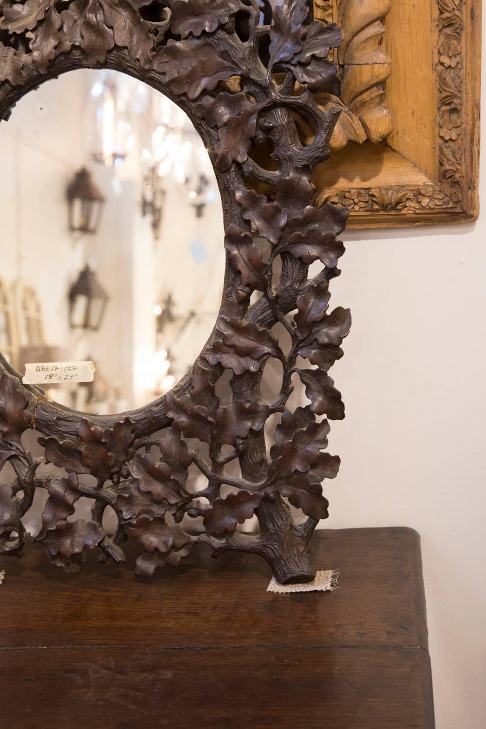 French Black Forest 19th Century Oak Leaves Carved Mirror with Oval Glass In Good Condition In Atlanta, GA