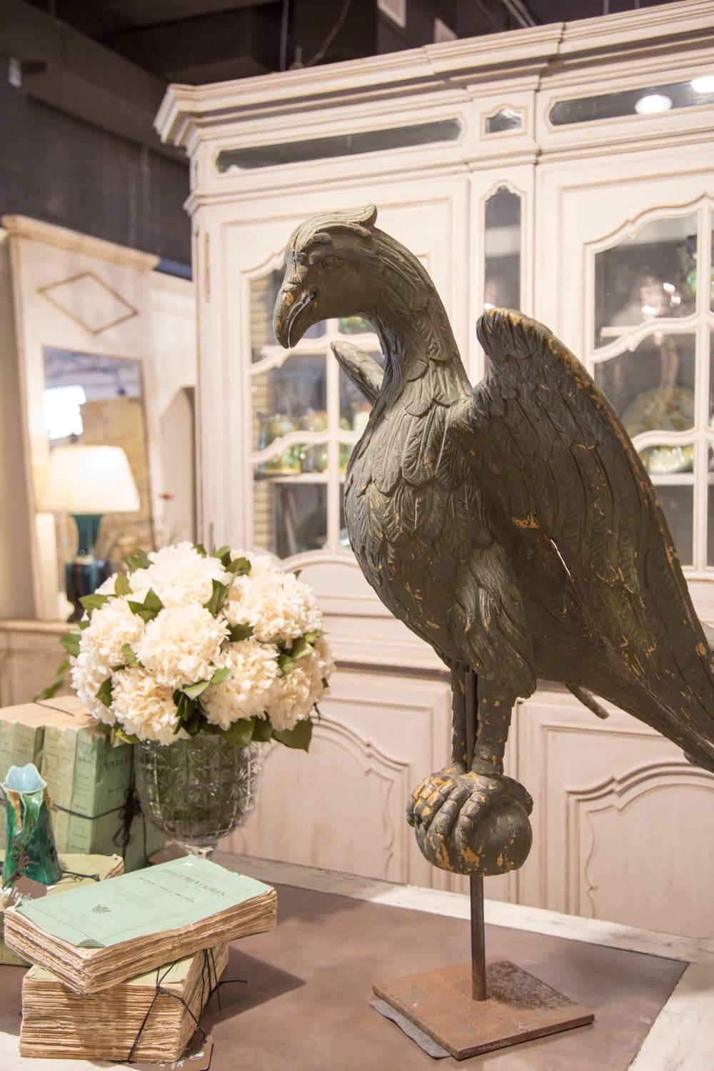 This large size hand-carved eagle lectern from the early 19th century on square custom metal stand is a show stopper! His head is slightly bent down with outstretched wings, as if he's ready to soar. The careful treatment of his body and feathers