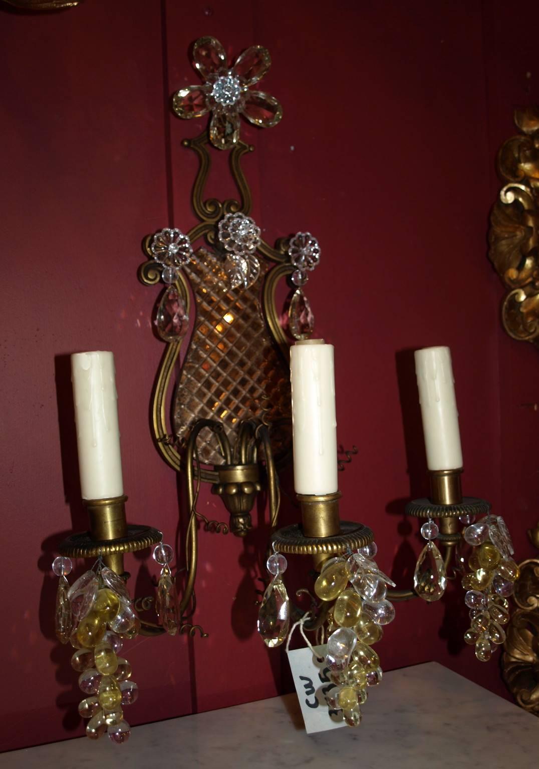 A very fine pair of gilt bronze and crystal three light Jansen sconces.