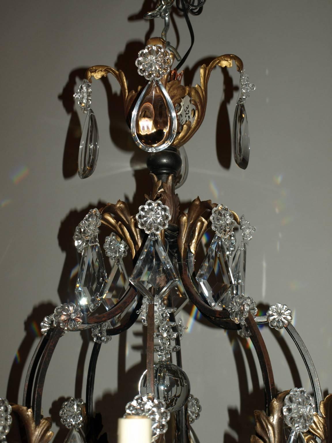 Superb cage style iron and gilt chandelier with crystal, eight arms.