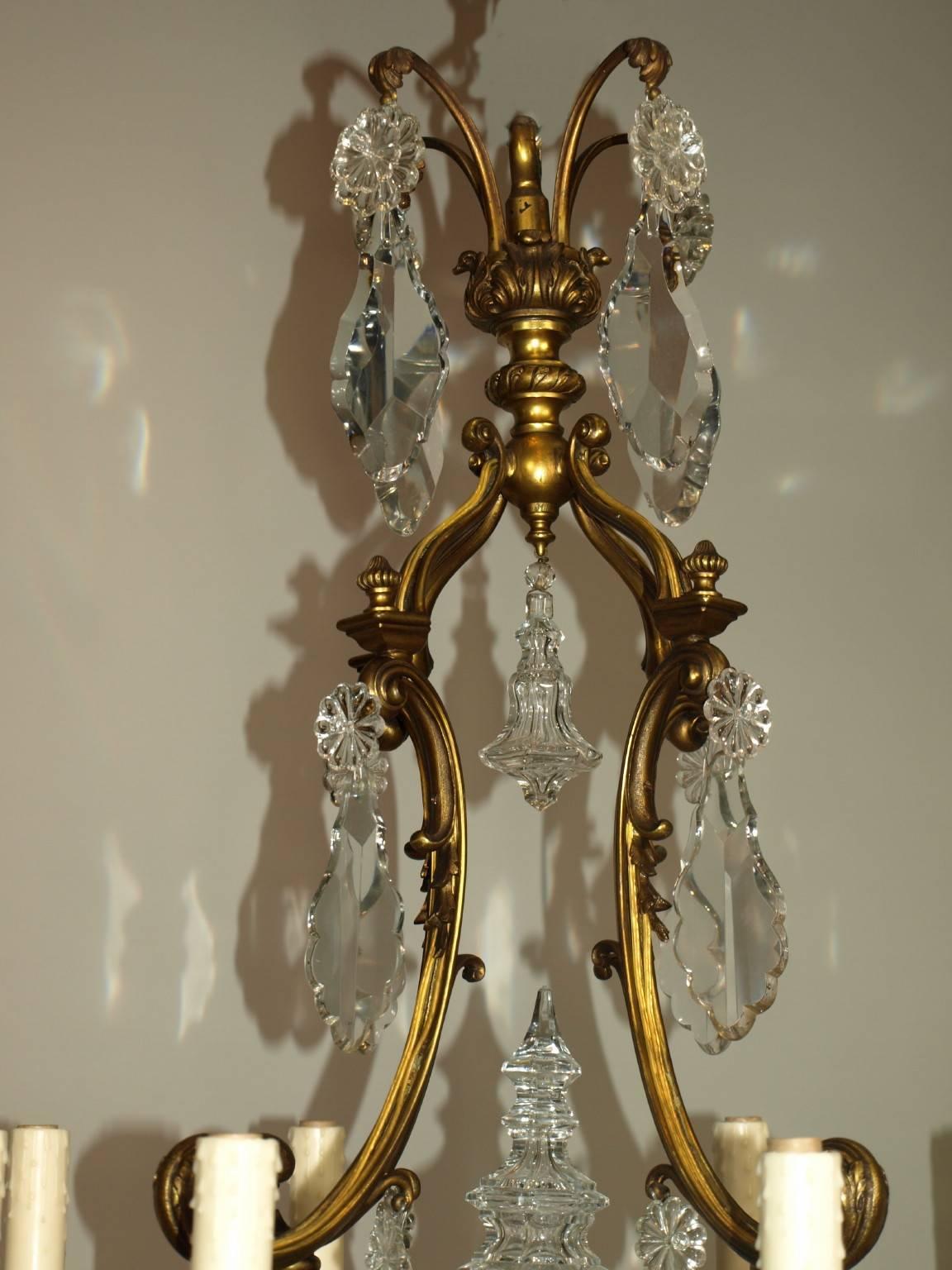Elegant gilt bronze and crystal chandelier featuring hand-cut crystal pendalogues, eight lights.