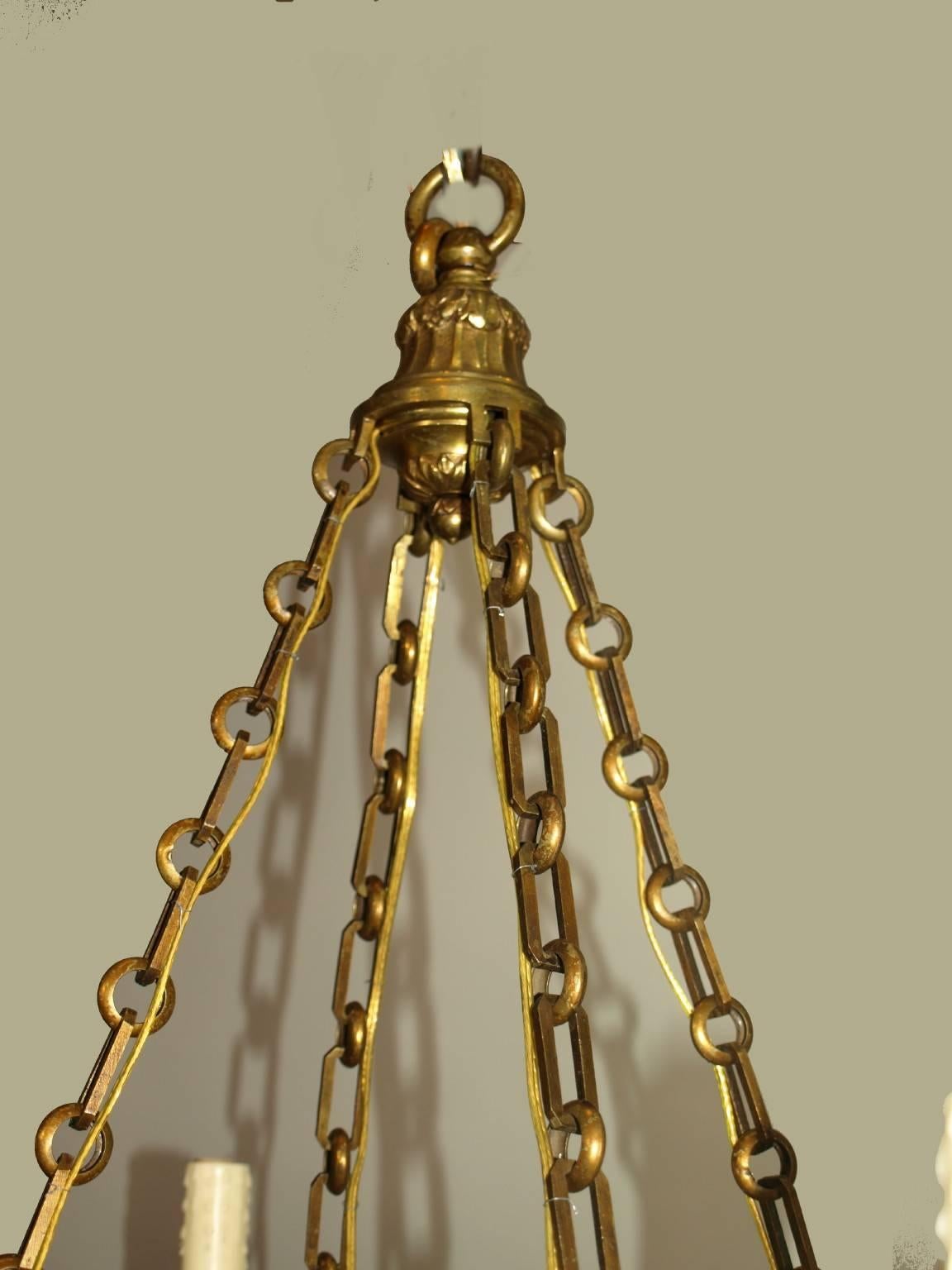 Very fine gilt bronze and alabaster chandelier having an elegant ram's head motif, suspended by heavy gilt bronze chains, and six lights.