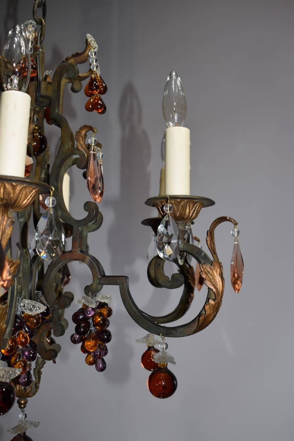 Painted and gilt iron chandelier having six lights and multicolored crystal fruit.