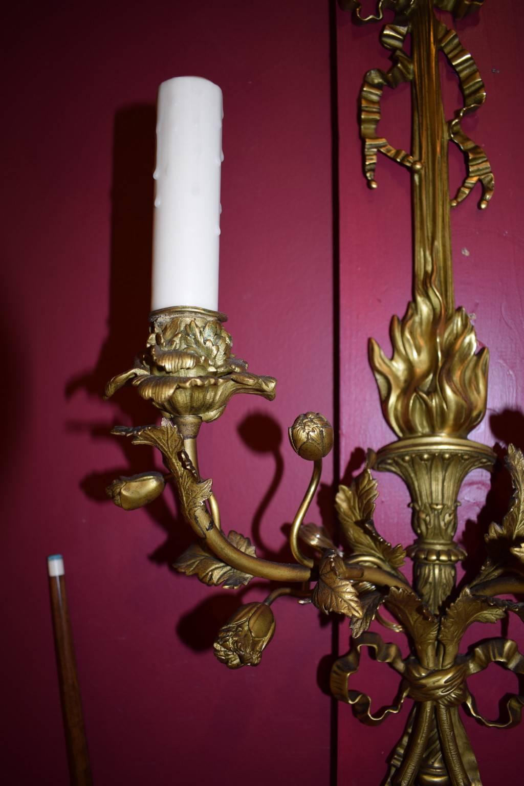 A truly magnificent pair of wall sconces, superb detail and craftsmanship, even the most minute details in the leaves and flowers are carefully rendered. A feast for the eyes! Gilt bronze with two lights.