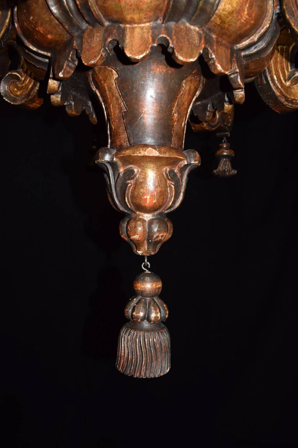 Superb 18th century hand-carved wood Venetian chandelier, partially gilt and polychrome. Originally for candles, now wired for electricity. Eight lights.