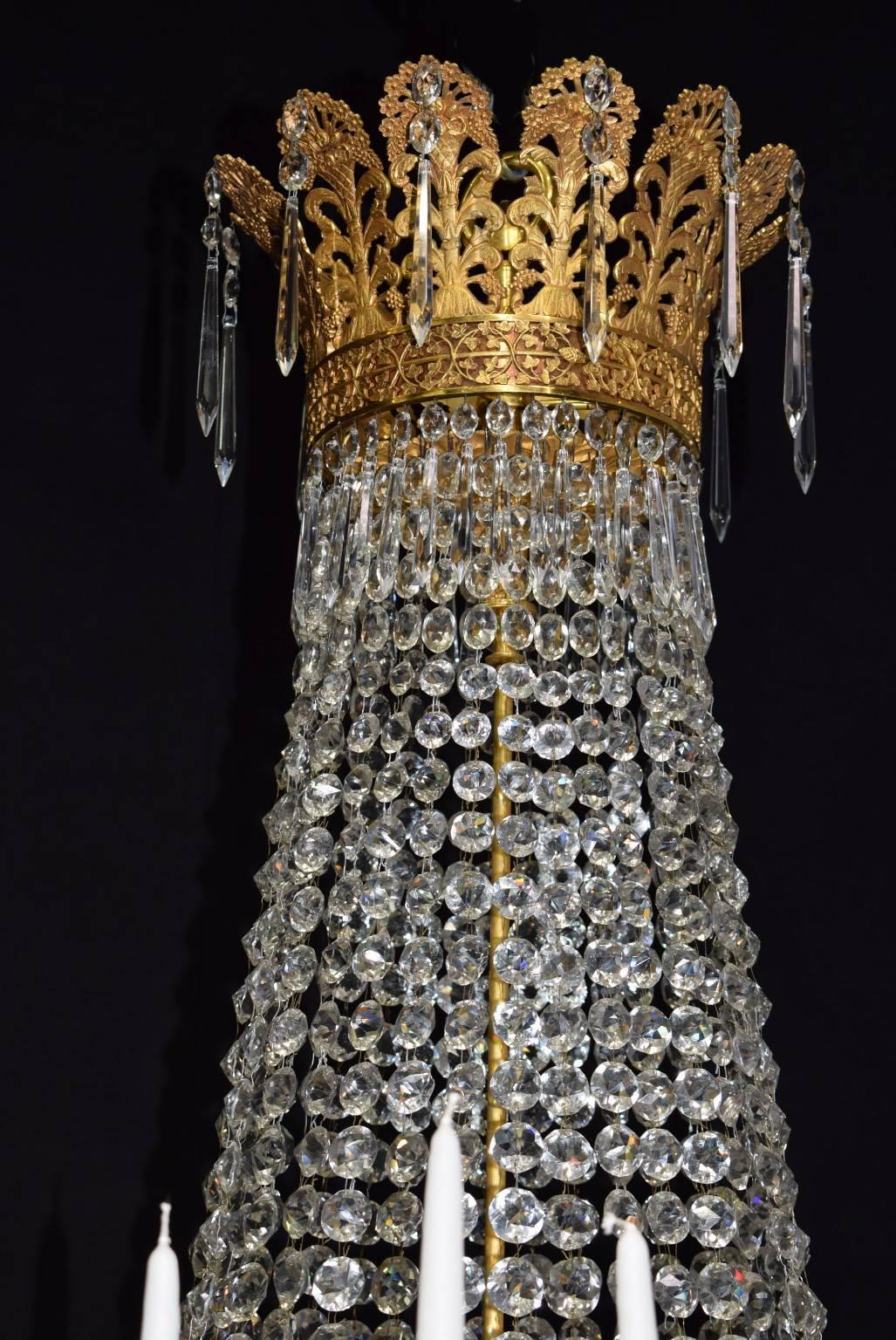 Exquisite and superbly detailed gilt bronze and crystal chandelier for candles, can be electrified.