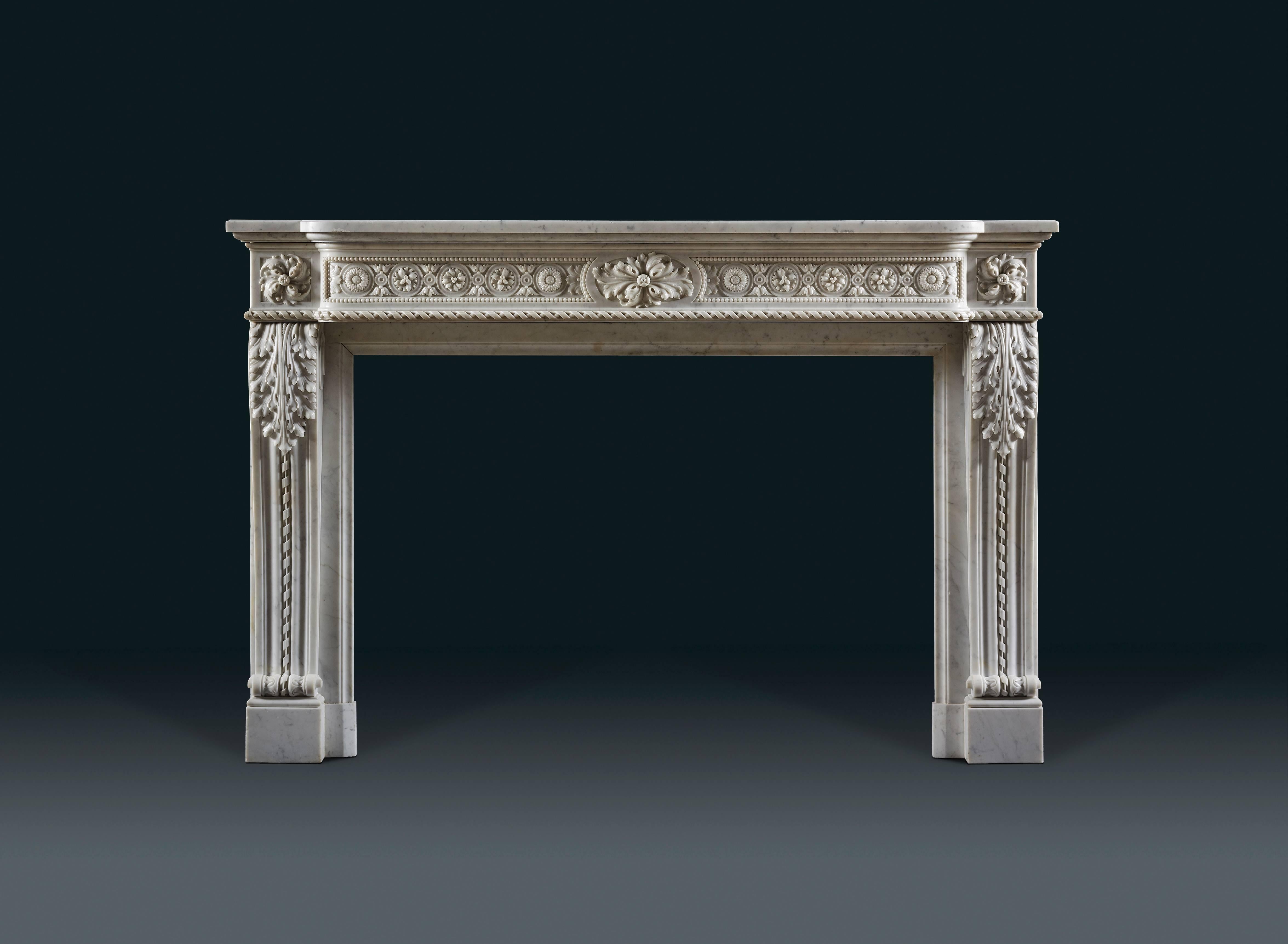 In statuary marble with bowed shaped frieze, centred with an oblong cartouche decorated with budding acanthus and flanked by panels with alternating flower heads in roundels joined by foliate rings. The stepped back jambs of ribbed 'S' shaped