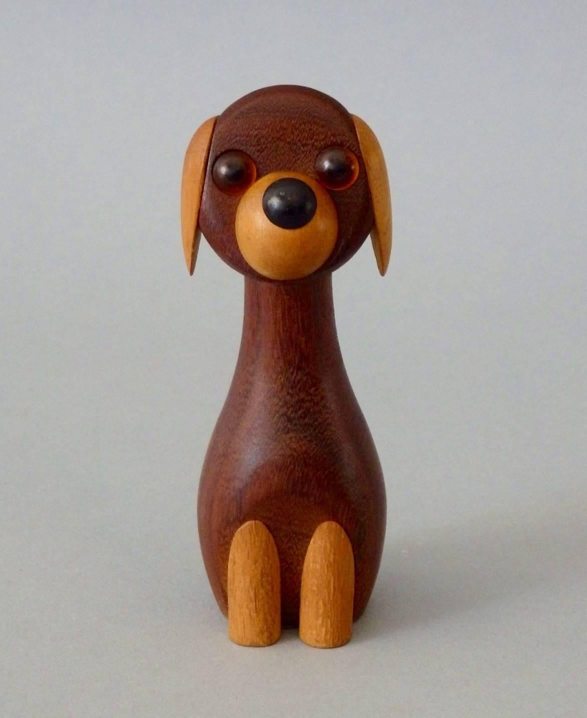 Kay Bojesen styled figure of a dog sitting up. Simple yet beautifully styled with glass or acrylic eyes and birch or beech legs. Retains original Laurids Lønborg paper label.