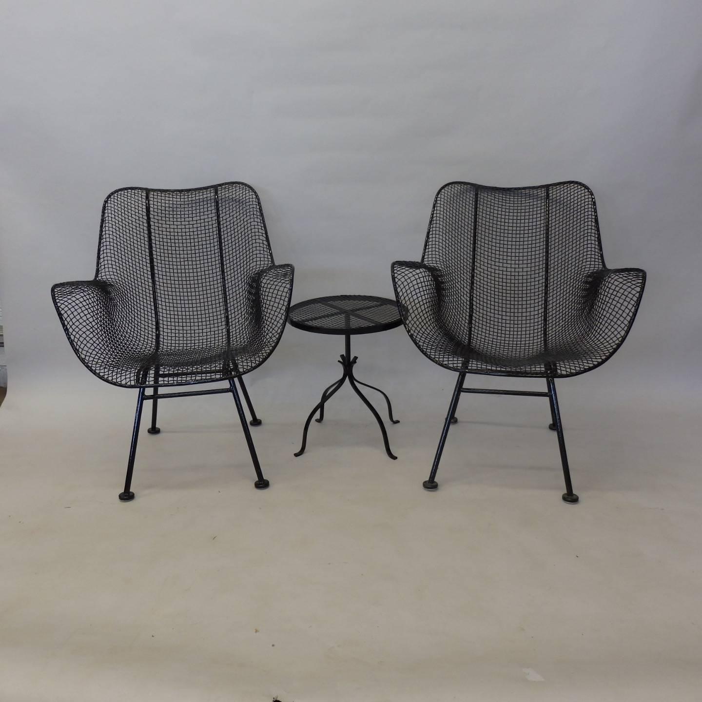 Pair of nicely restored Woodard high back lounge chairs. Small occasional table drinks stand makes for a nice three-piece set . All pieces are powder coated in gloss black with new foot glides installed.