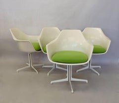 Four Burke white fiberglass swivel dining chairs