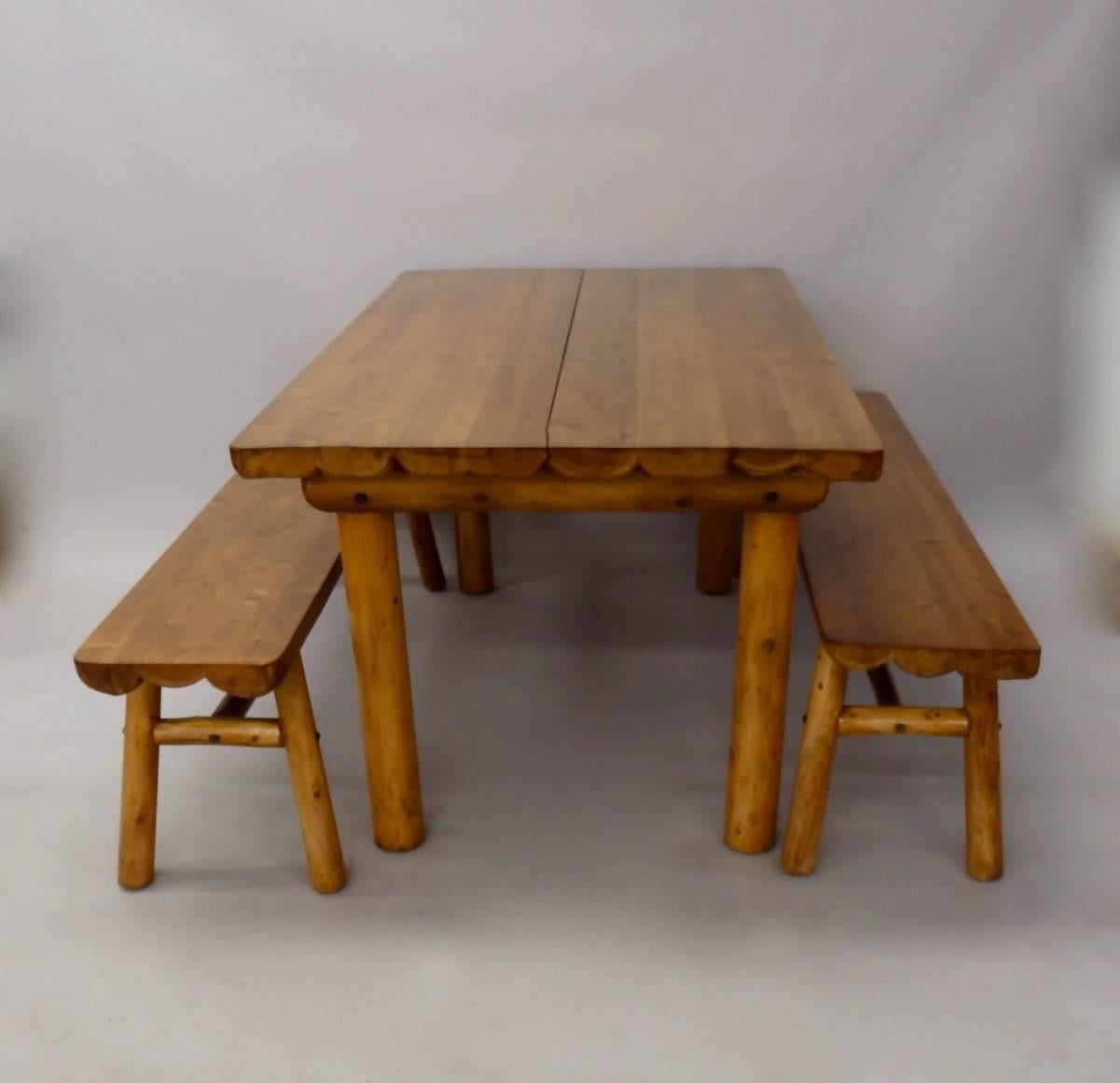 Adirondack style rustic ranch, cabin or cottage table with two benches. I believe this is Cedarwood. Table and bench tops are half logs with log / branch stretchers.
Measurements are for the table. Benches measure 12 x 60 at 18 tall.