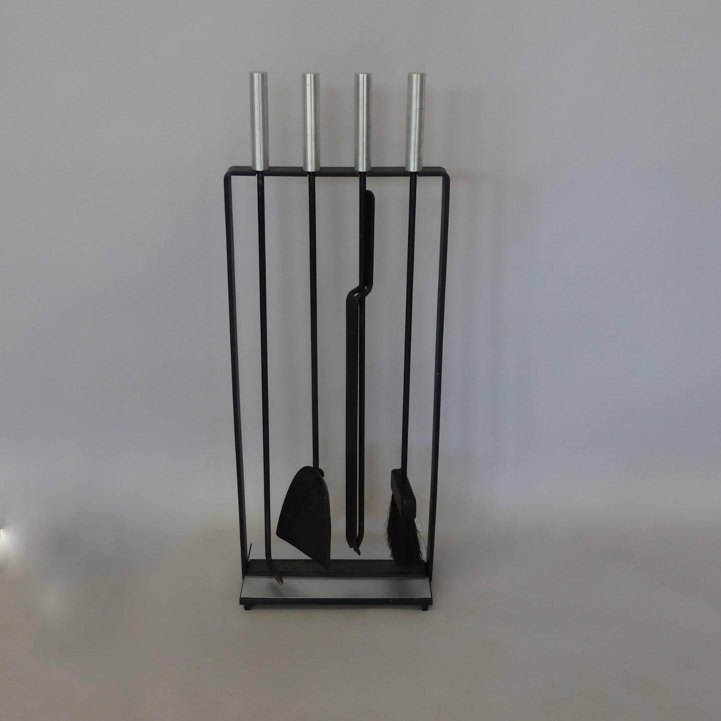 Four-piece modernist tool set in stand.