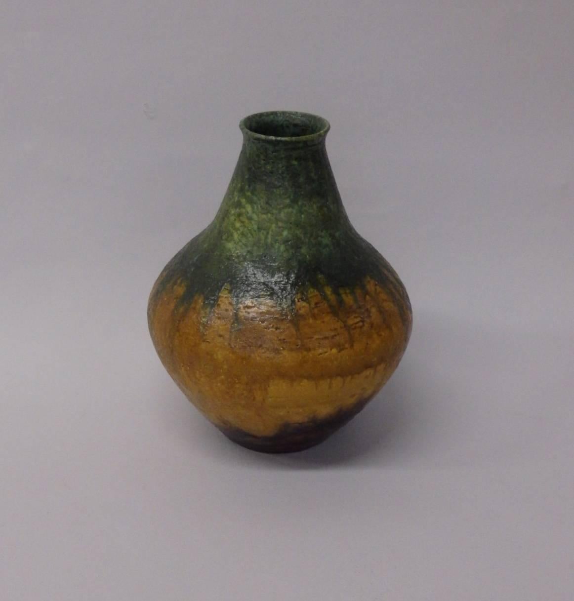Italian ceramic vase by Marcello Fantoni. Green and mustard glaze on bulbous form.
