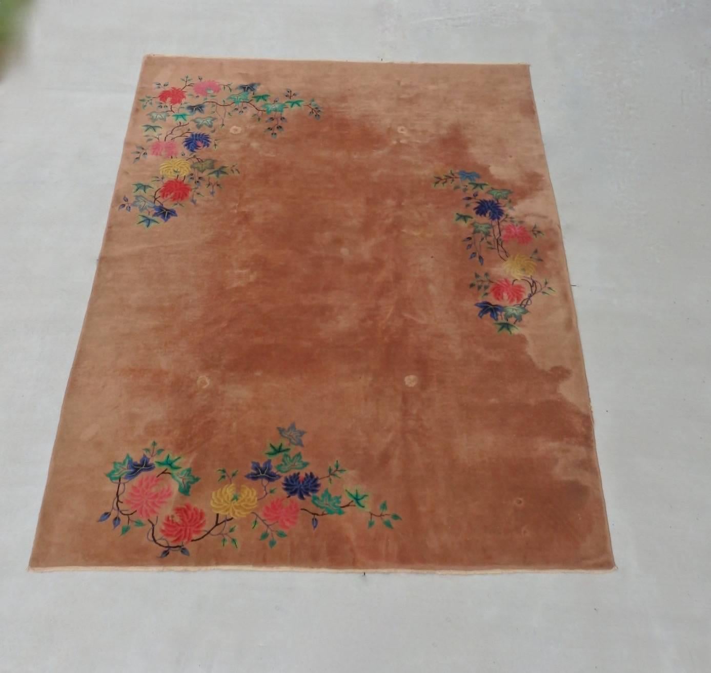 Large Art Deco rug with floral motif on rare Mink tone field. Fresh from an estate table leg imprints are still fresh.
