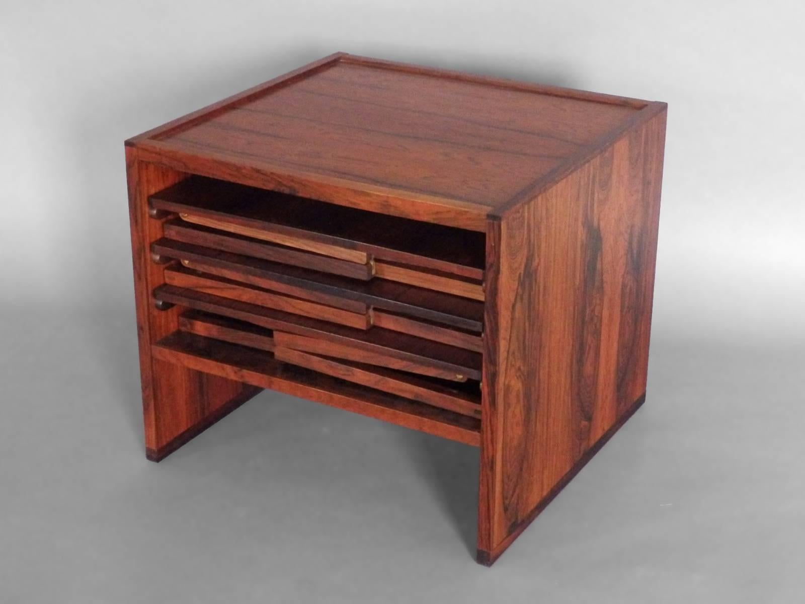 Beautifully grained rosewood cabinet holding three similarly grained nesting tables . Each table fitted with brass hardware . Sold by Ilums Bolighus Denmark .
Each table: 16.5 wide x 16.5 deep x 16 tall
Storage cube: 18 wide x 17 deep x 16.25 tall.