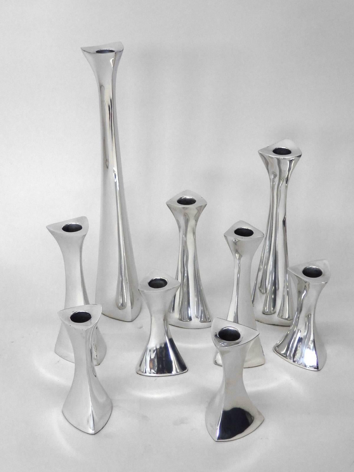 Twelve in total . Cast and polished aluminum candle sticks . Richard K. Thomas designer for Nambe
Bases measure: 2 5/8” wide x 2 5/8” deep, 2 at tallest at 14.25”, one at 9.5