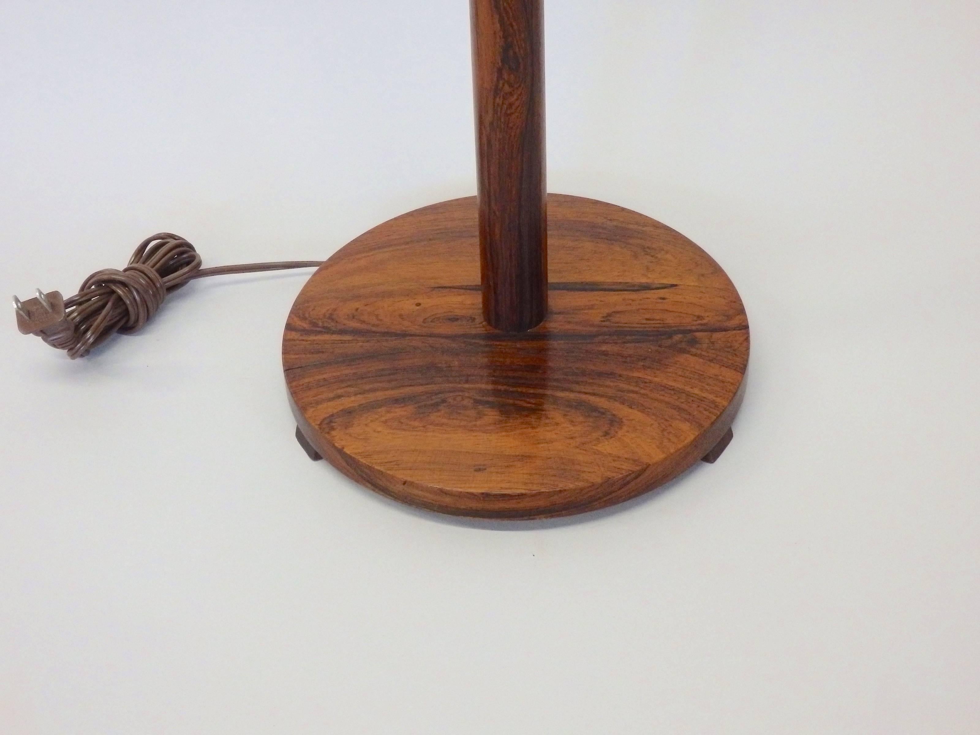 Rosewood base and shaft floor lamp. Tag on underside reads made in Sweden.