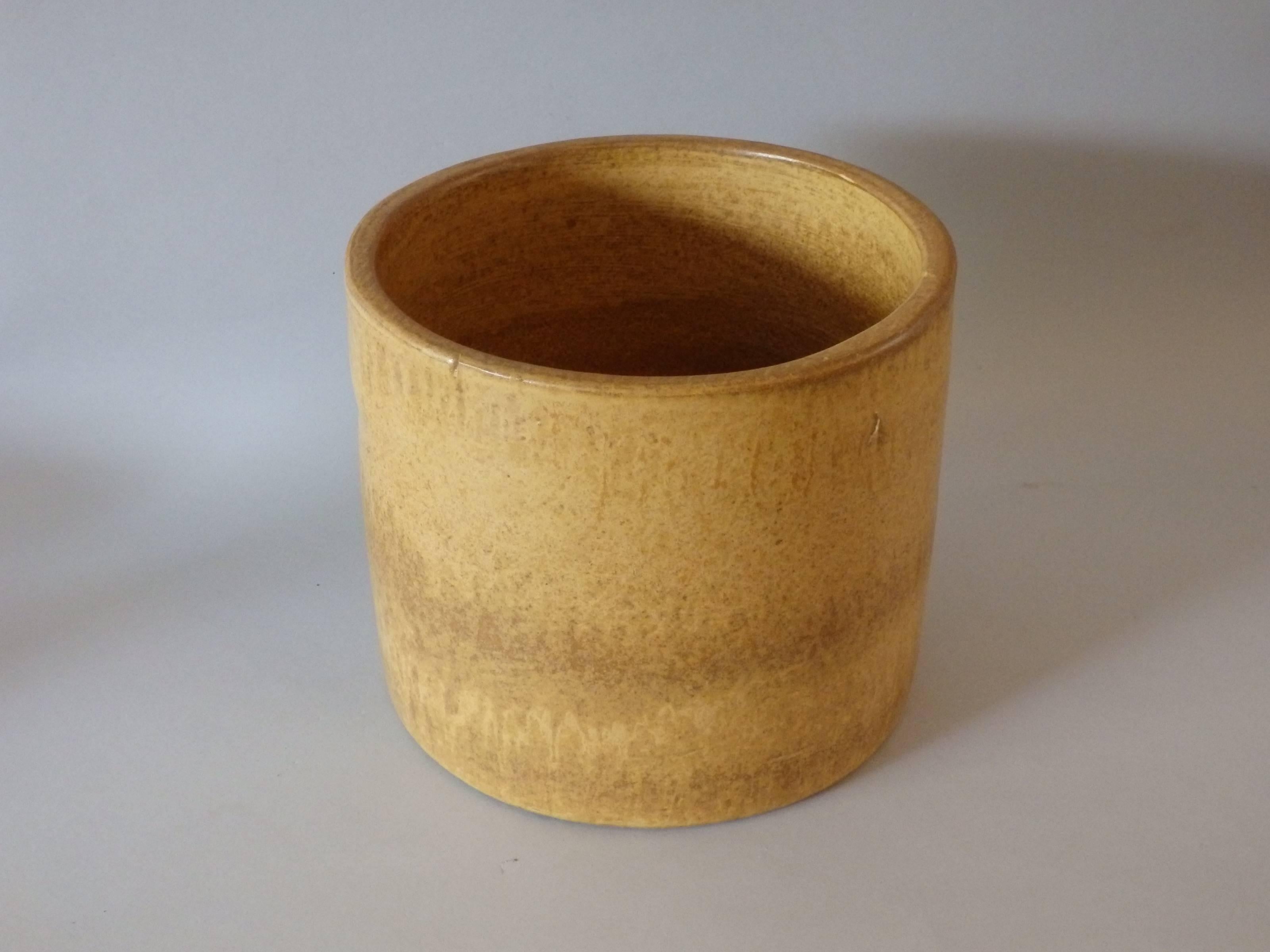 Clean mustard marigold glaze cylinder form planter pot. In the style of architectural pottery but un signed.