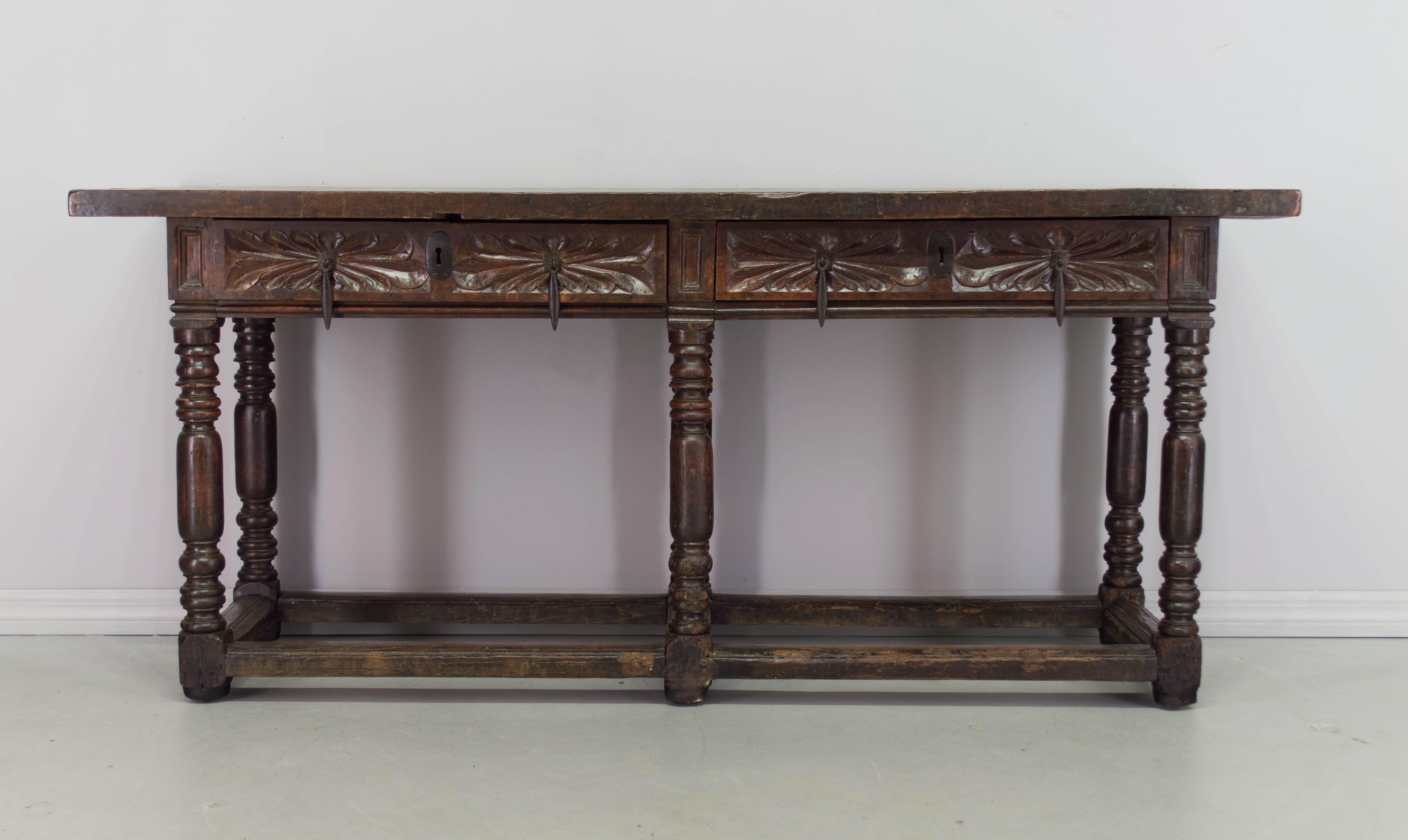 18th century Spanish Baroque console or center table made of solid walnut with pegged construction. Two dovetailed drawers with original iron pulls. Top is made form one 1-1/2