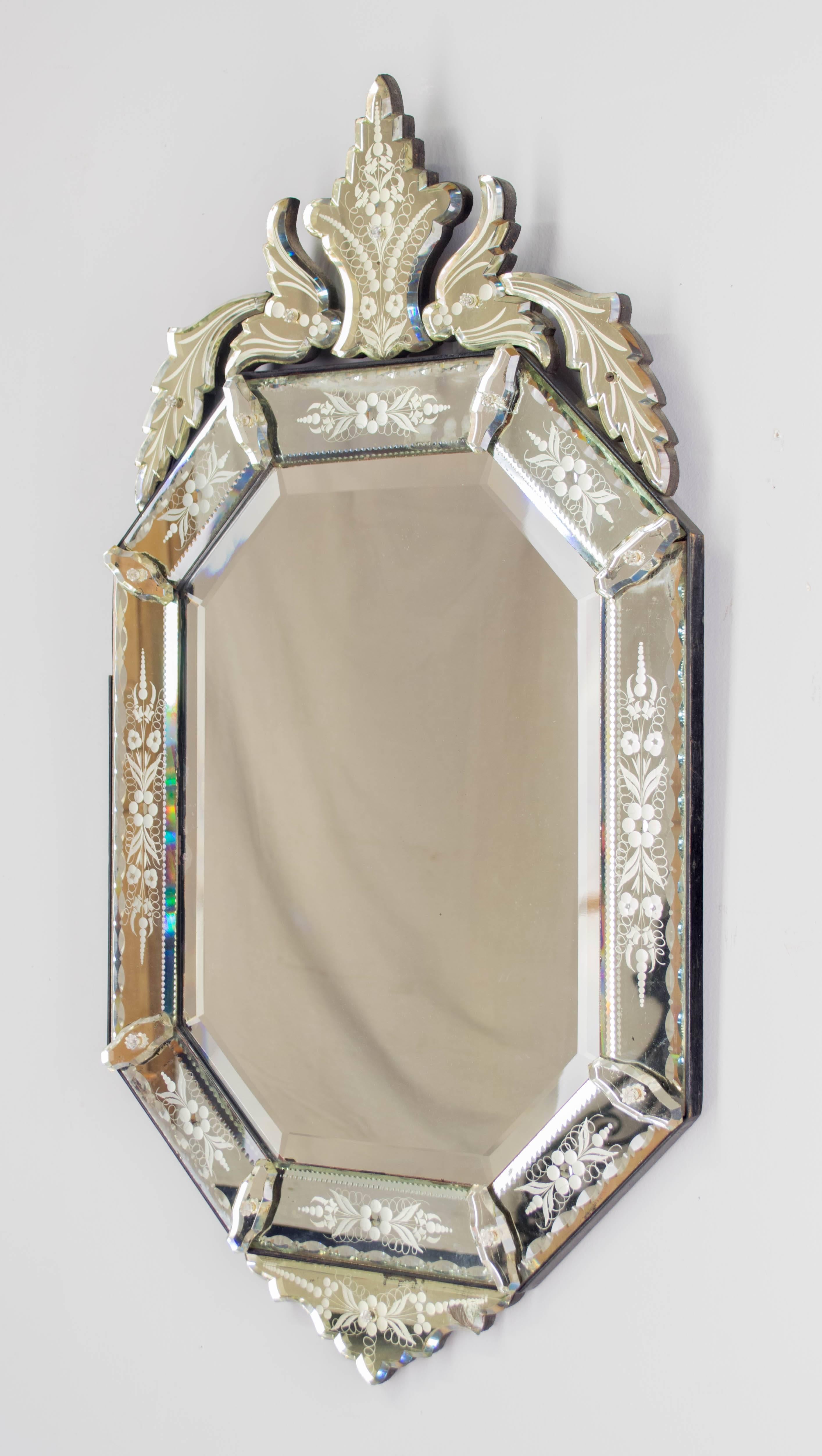 19th century Napoleon III Venetian mirror in an octagon shape with 22 separate pieces that have been cut, beveled and etched with lovely floral motif. Elegant shape of the crown and delicate etched details. One small piece in upper right corner is