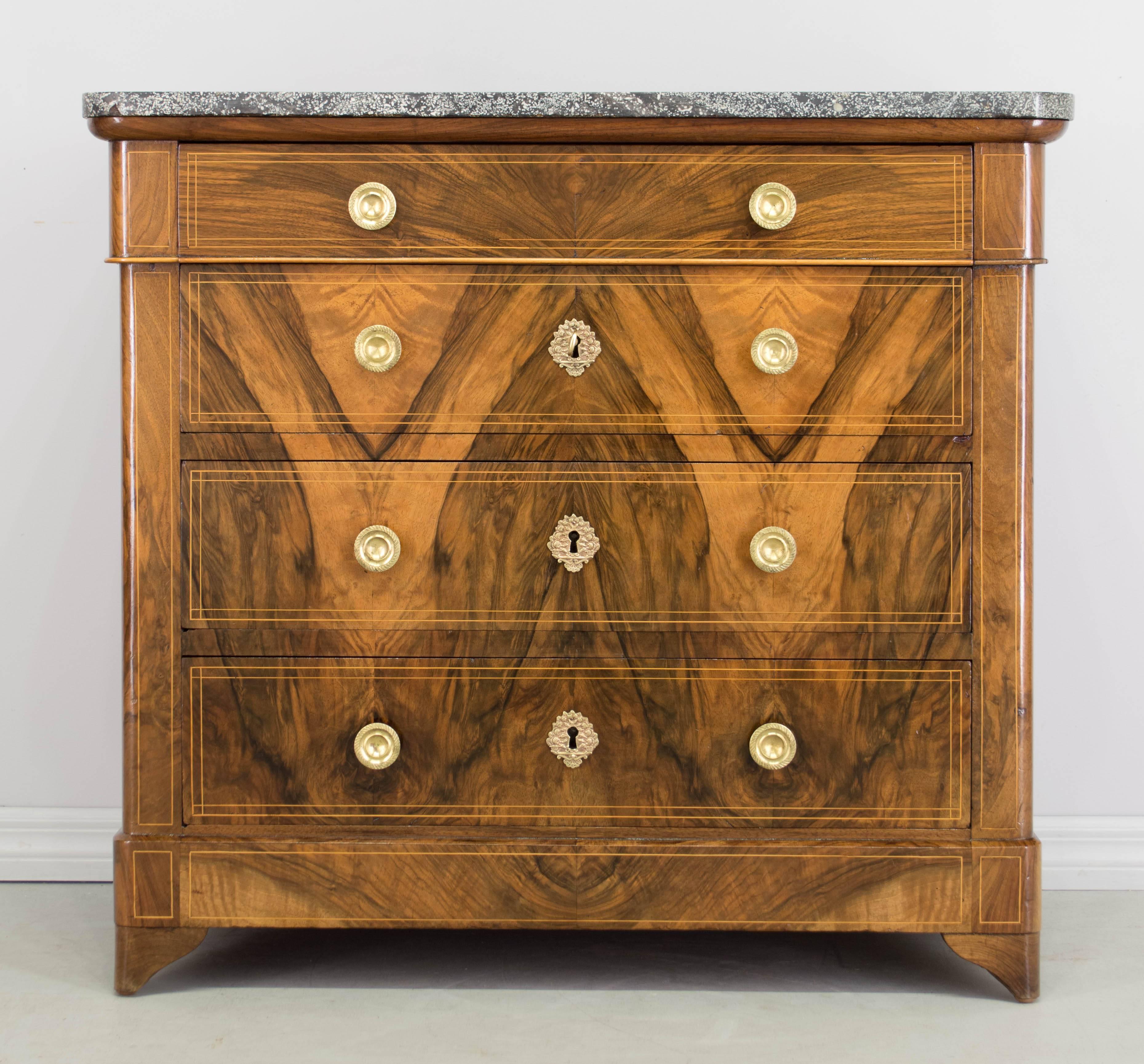 A fine period 19th century Louis Philippe commode with four dovetailed drawers and book-matched veneer of walnut front. Sides are solid walnut with beautiful wood grain. Oak as a secondary wood. Excellent quality, note the precise linear inlay