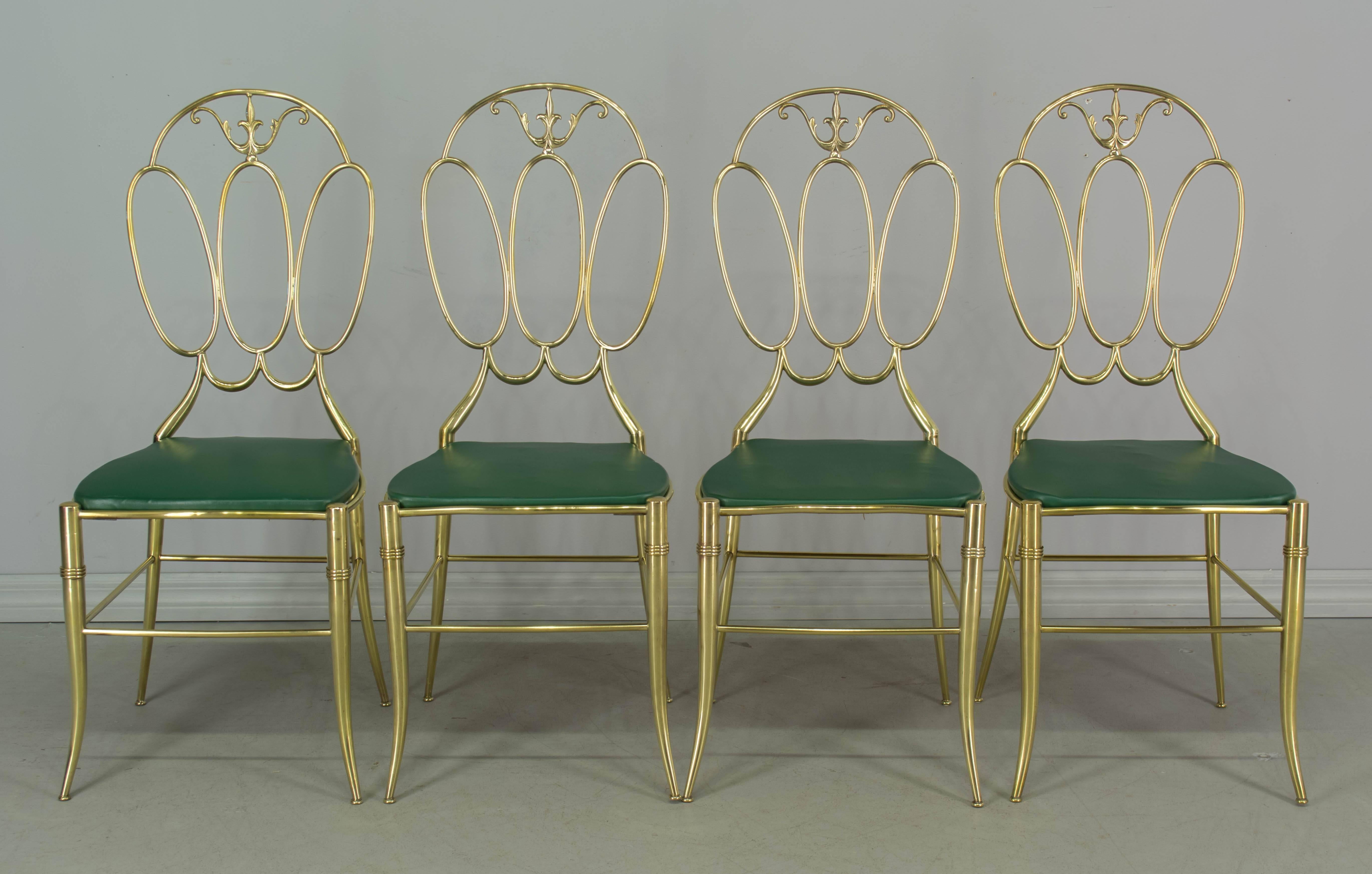 Set of four Italian brass chairs attributed to Chiavari. In excellent condition and very sturdy. Brass has been polished, but not lacquered. Original green vinyl covered seats. Stamped on underside: Made in Italy. 16