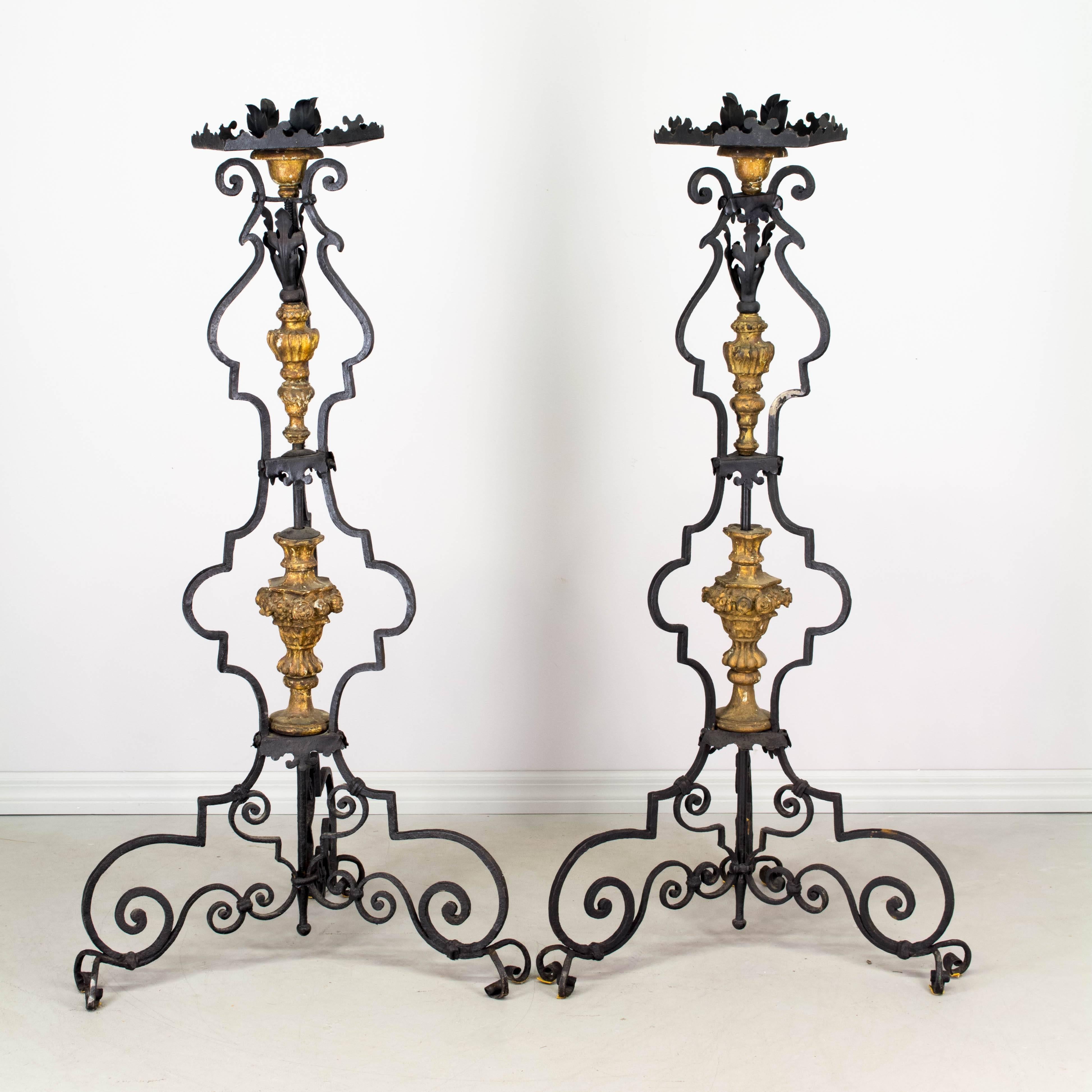 Pair of 19th century Italian wrought iron large floor torchieres with carved gilded wood decoration. In good original condition with minor losses.
More photos available upon request. We have a large selection of French antiques. Please visit our