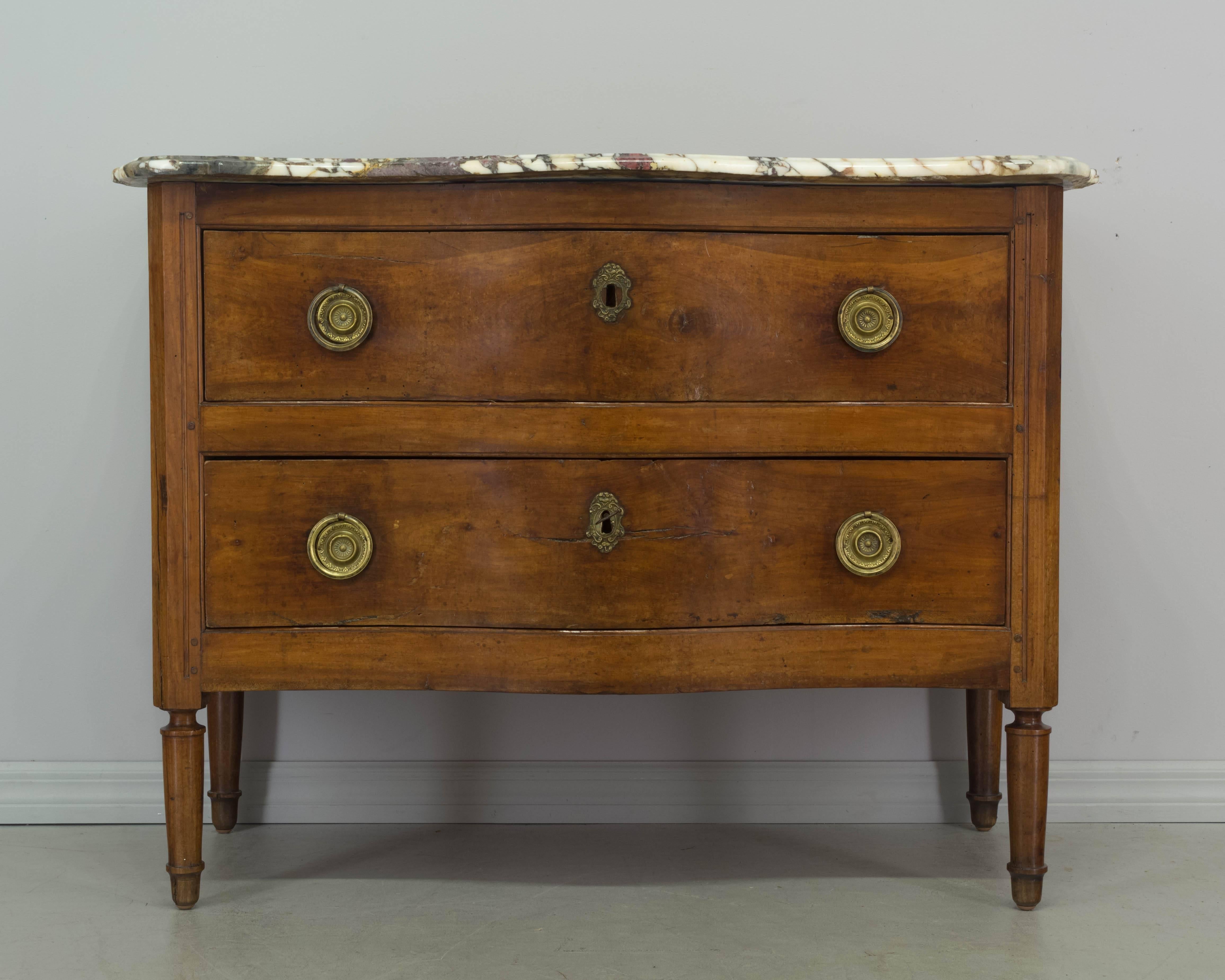 18th century Louis XV commode with serpentine front and curved sides. Made of solid cherry with pegged construction. Two dovetailed drawers with original brass hardware, working locks and one key. Original marble-top with shaped front corners. Pine