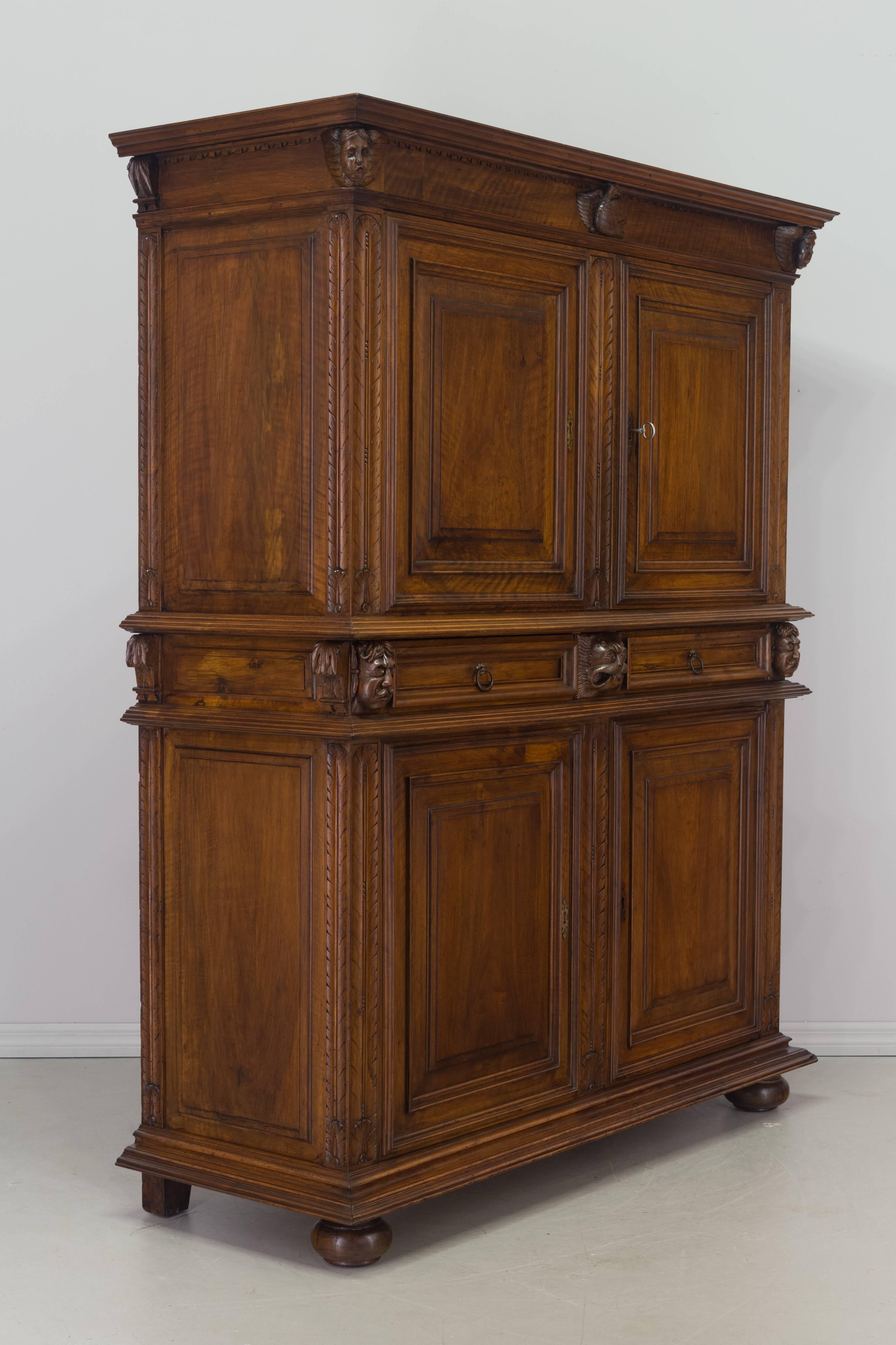 19th century Louis XIV style buffet à deux corps, or two-part buffet, made of solid walnut with four doors and three dovetailed drawers. Nice hand-carved sculptural details. The bottom opens to one interior shelf and the upper part provides ample