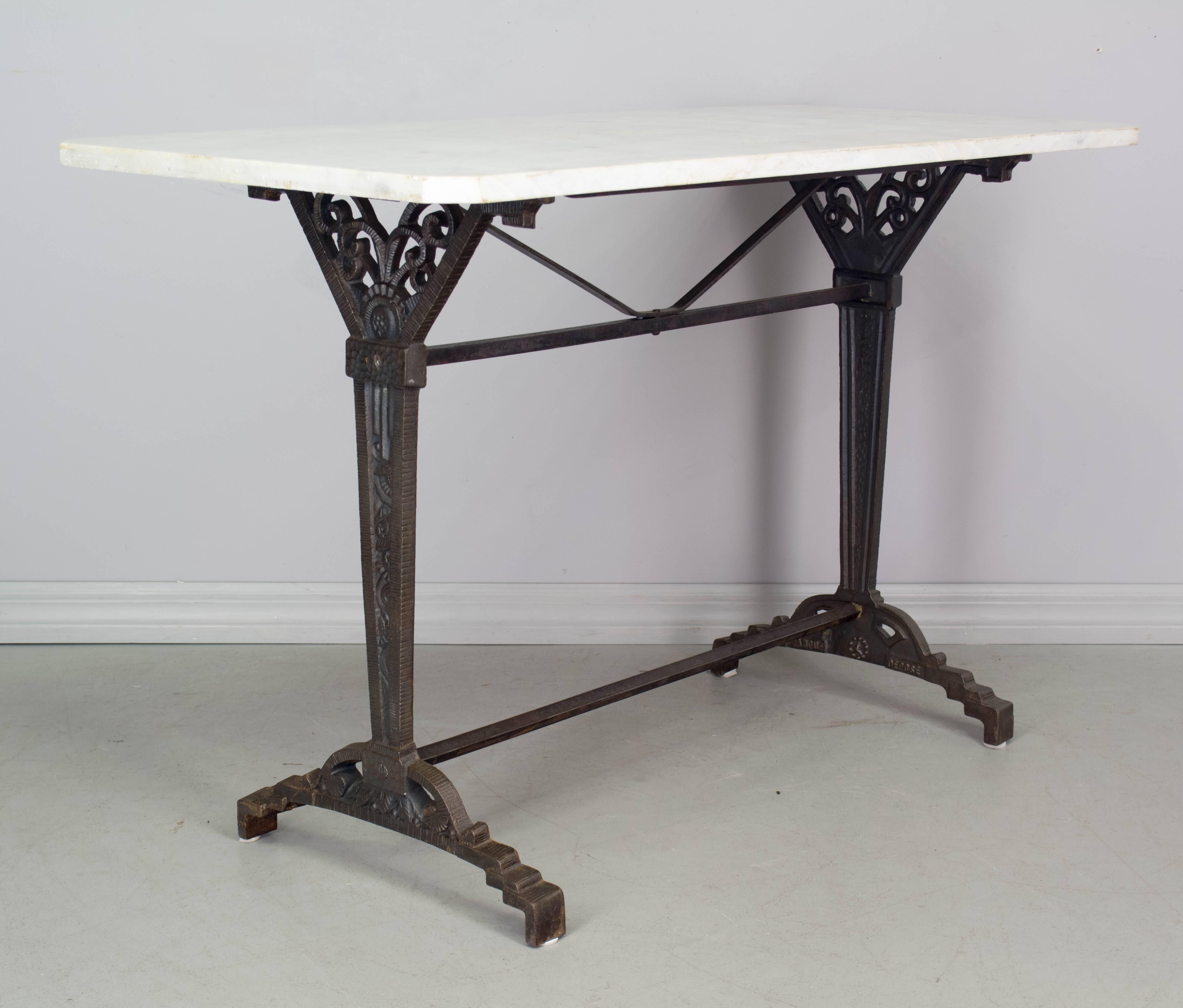 French Art Deco cast iron bistro table. Marble-top is not original, but as found with the base. Base is stamped: Marque Deposé (Patented).