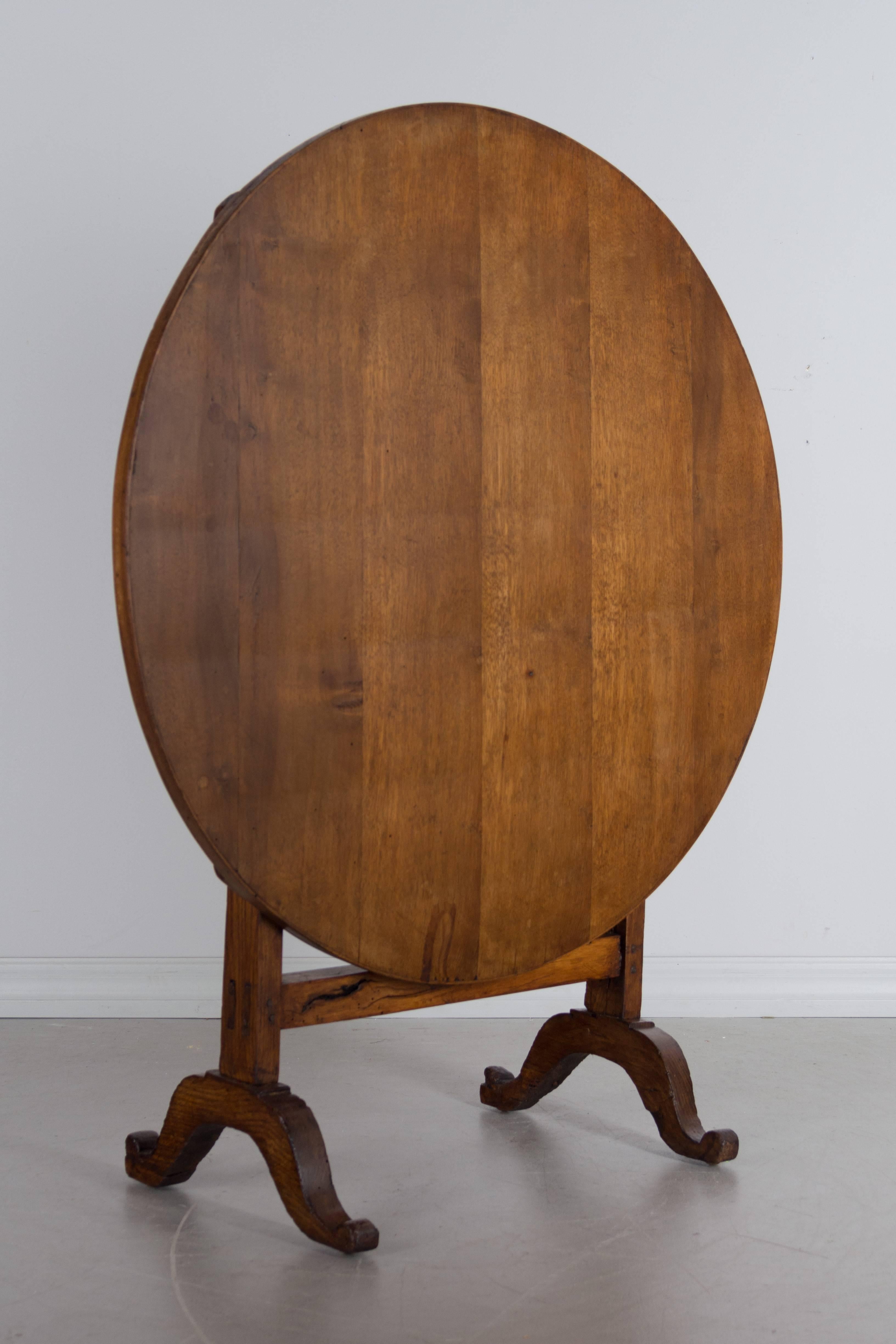 A 19th century French tilt-top wine tasting table made of solid oak. Waxed patina. The top has been restored with new planks added at a later date. Height when tilted is 43".
More photos available upon request. We have a large selection of
