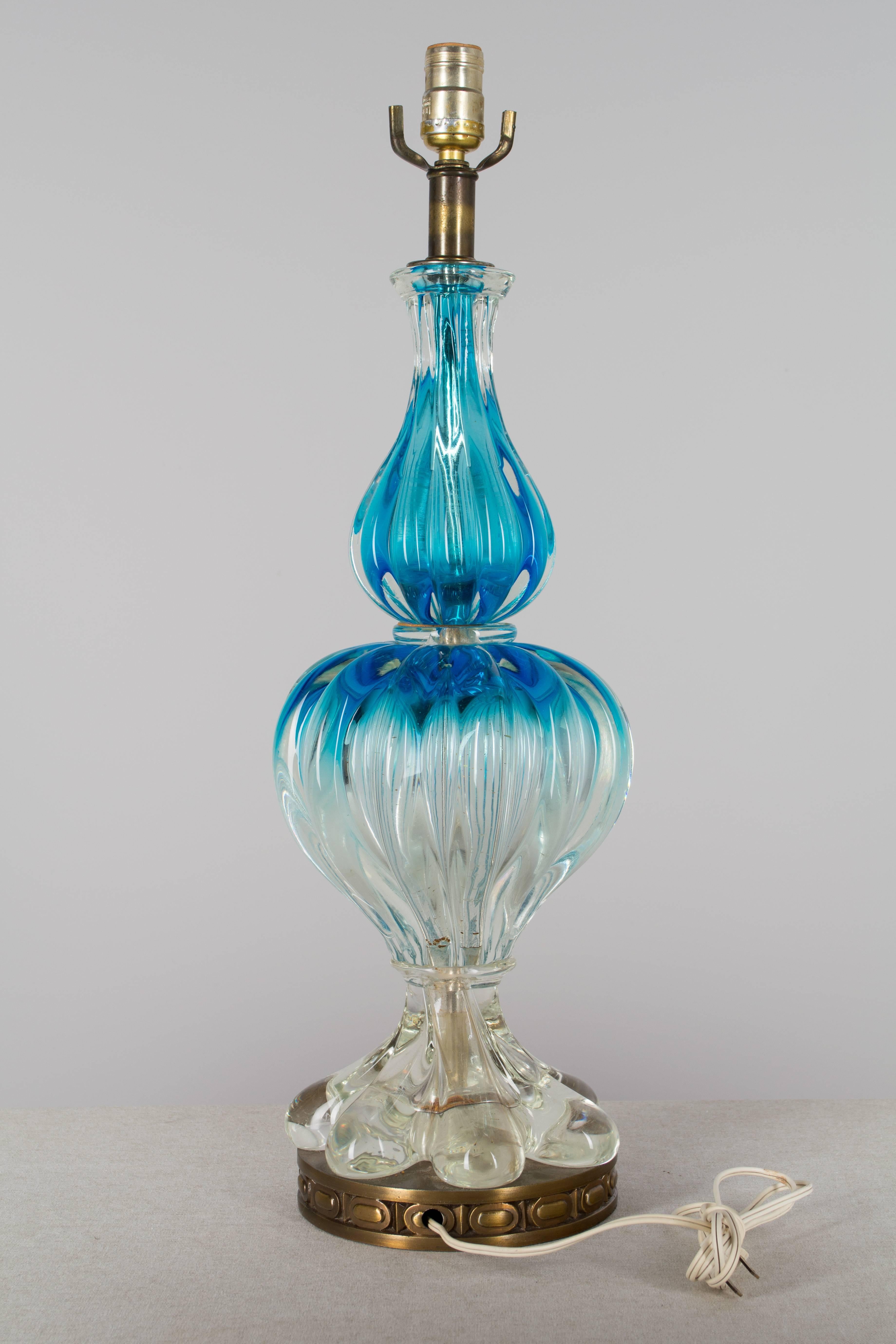 Mid-Century Murano glass lamp in beautiful aquamarine color with blue at the top and fading to clear at the bottom. Three heavy, thick ribbed, handblown glass pieces. Original metal base. This lamp has not been rewired, but is in working condition.