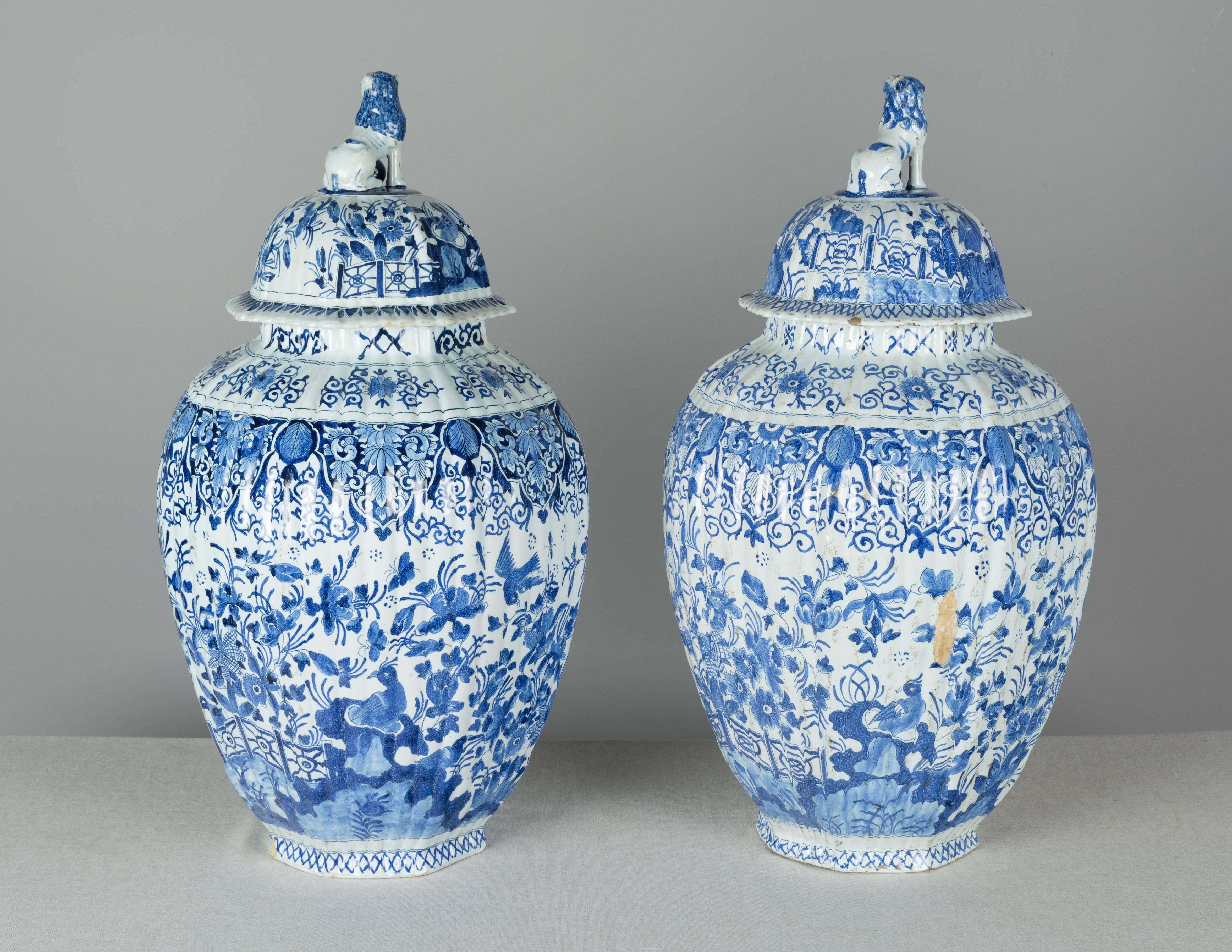 Pair of large 17th century delft faience lidded ginger jars with Chinoiserie decoration of birds and flowers inspired by the blue on white décor of Ming porcelain. Each bears the monogram LC, for Lambertus Cleffius, who directed the ceramics factory