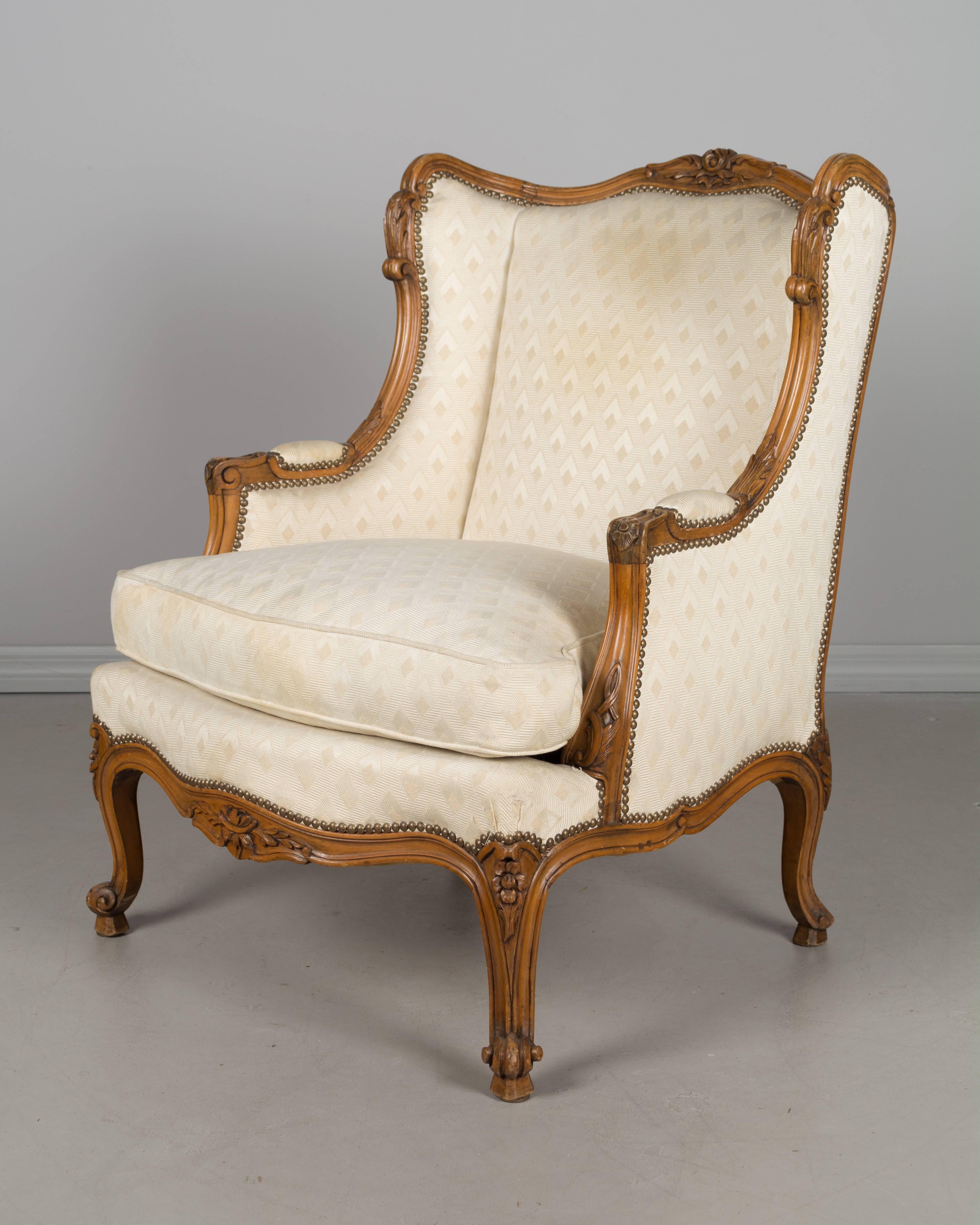 A pair of French Louis XV style bergere, or arm chairs, made of beechwood with carved details. Sturdy and very high quality with comfortable seating. Original worn upholstery with down seat cushion with some stain.
More photos available upon