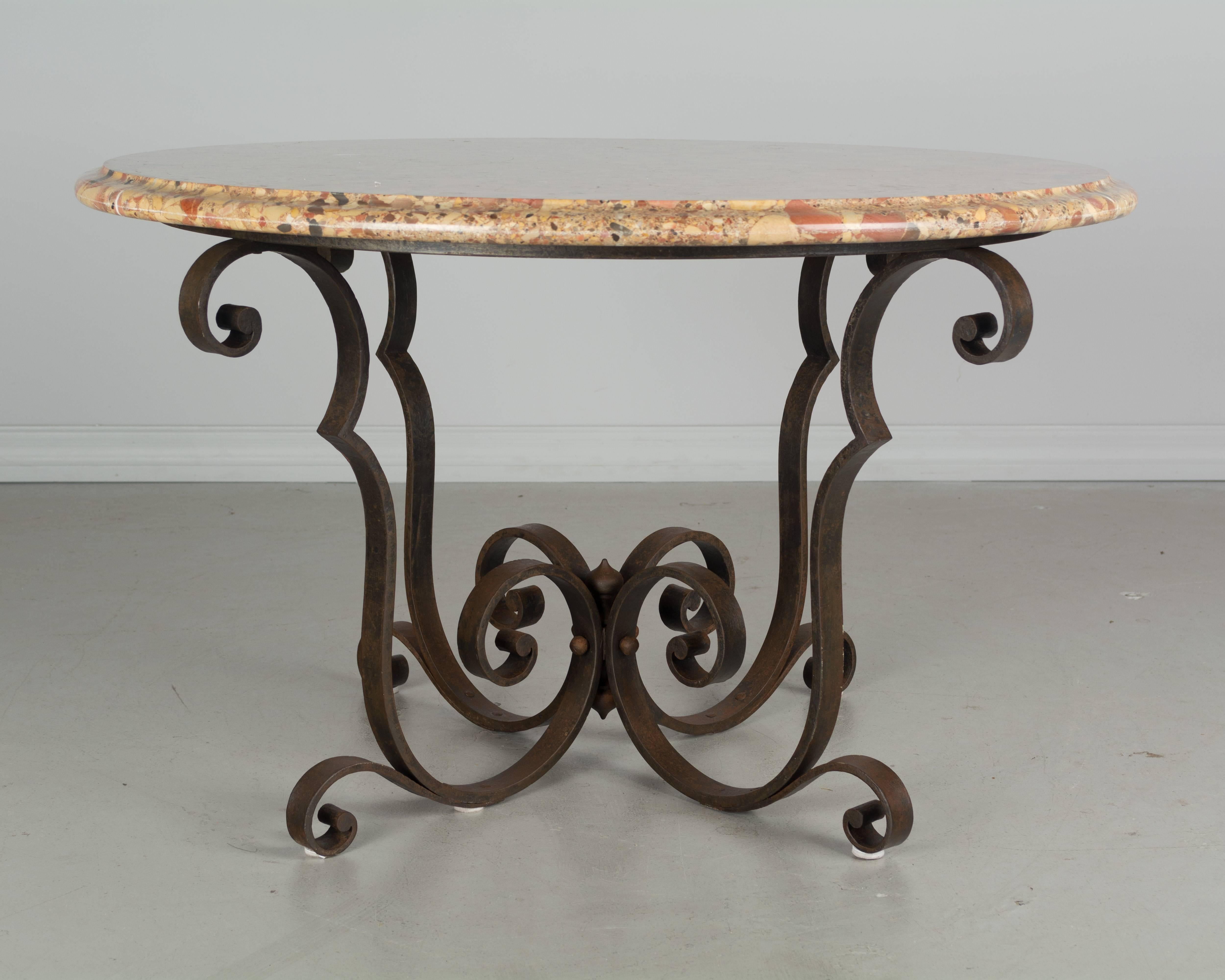 French Art Deco wrought iron coffee table with original Breche d'Alep marble top. 
More photos available upon request. Please visit our showroom in Winter Park, Florida.