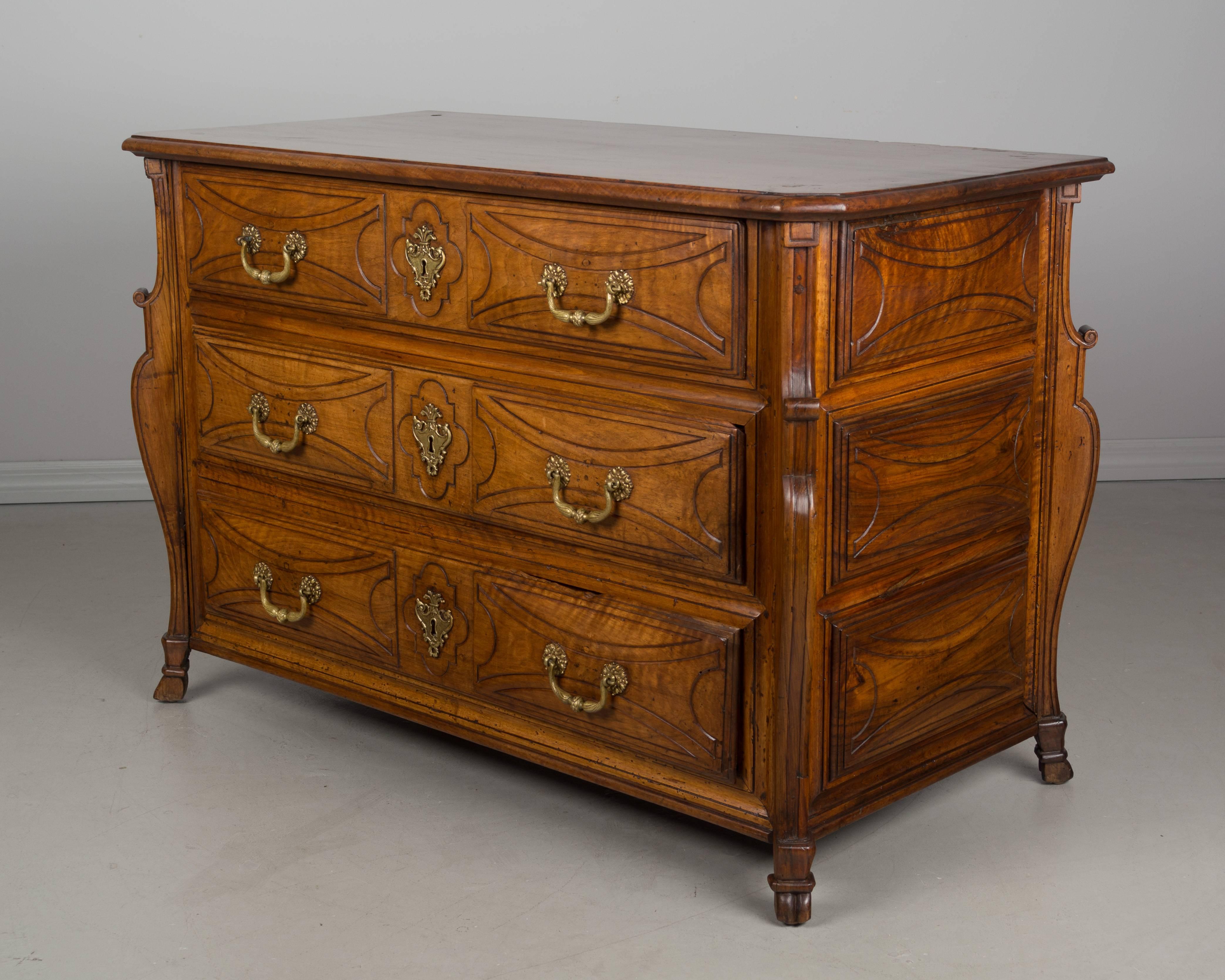 A fine 18th century Louis XVI commode from the town of Castres the Southwest of France and in a style that is typical of this region. Made of solid walnut with three dovetailed drawers and three raised panels on the sides, all convex surfaces with