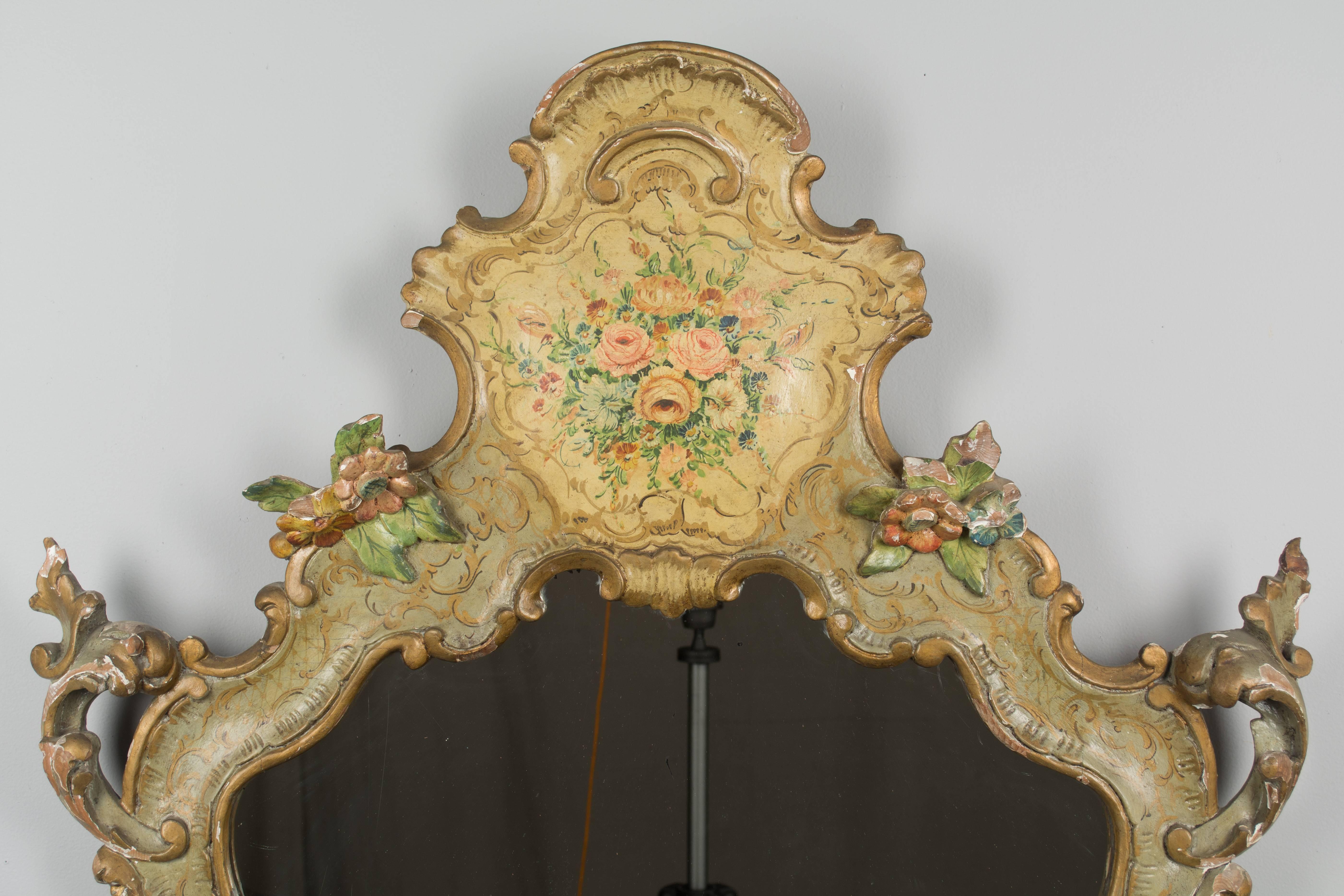 A 19th century painted Venetian mirror. Elaborately carved Rococo style frame with hand-painted floral decoration. All original with some paint loss.
More photos available upon request. We have a large selection of French antiques at Olivier Fleury,