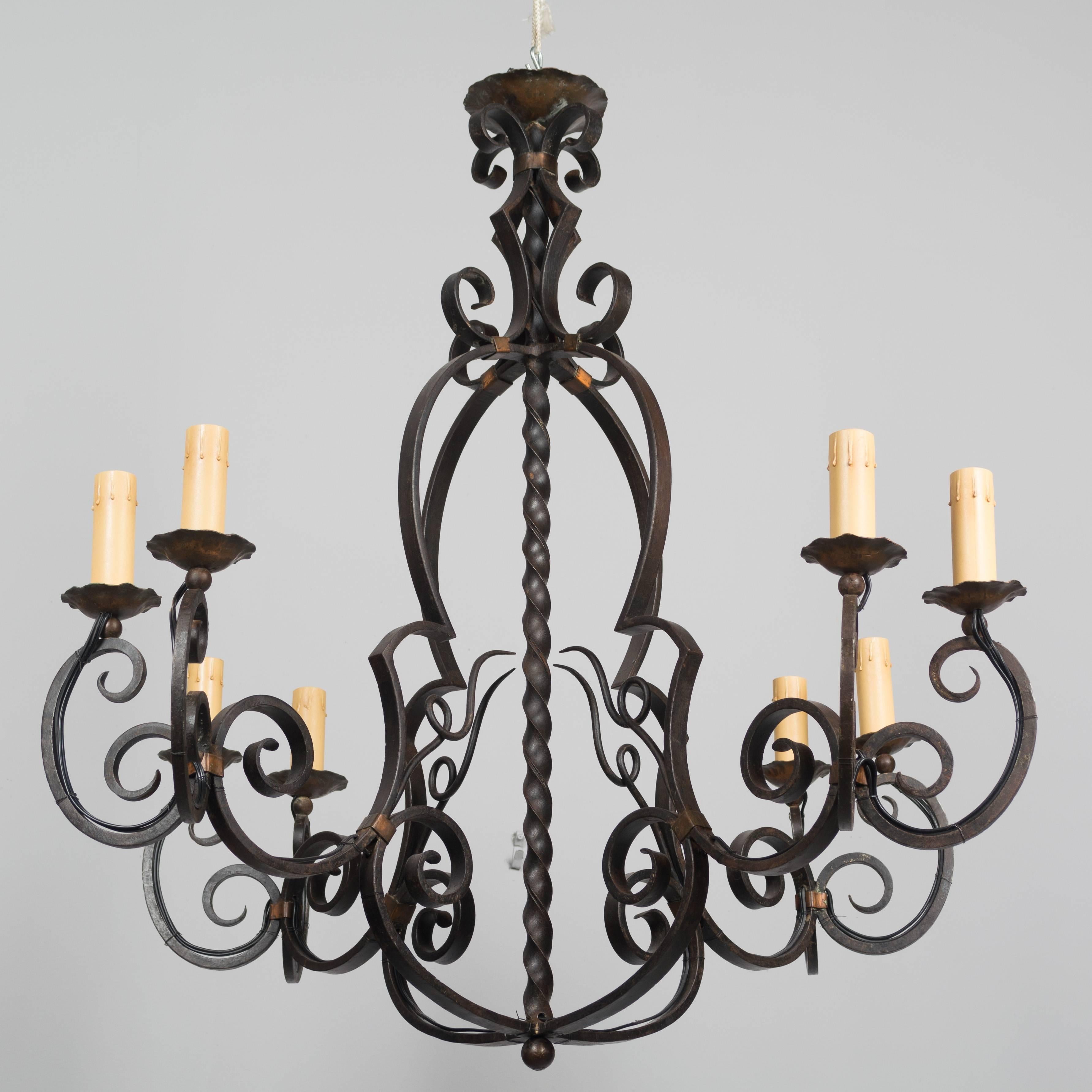 A large French eight light wrought iron chandelier. Beautifully crafted iron work and nice old patina with the bobeches and binding made of copper. Rewired.
More photos available upon request. We have a large selection of French antiques. Please
