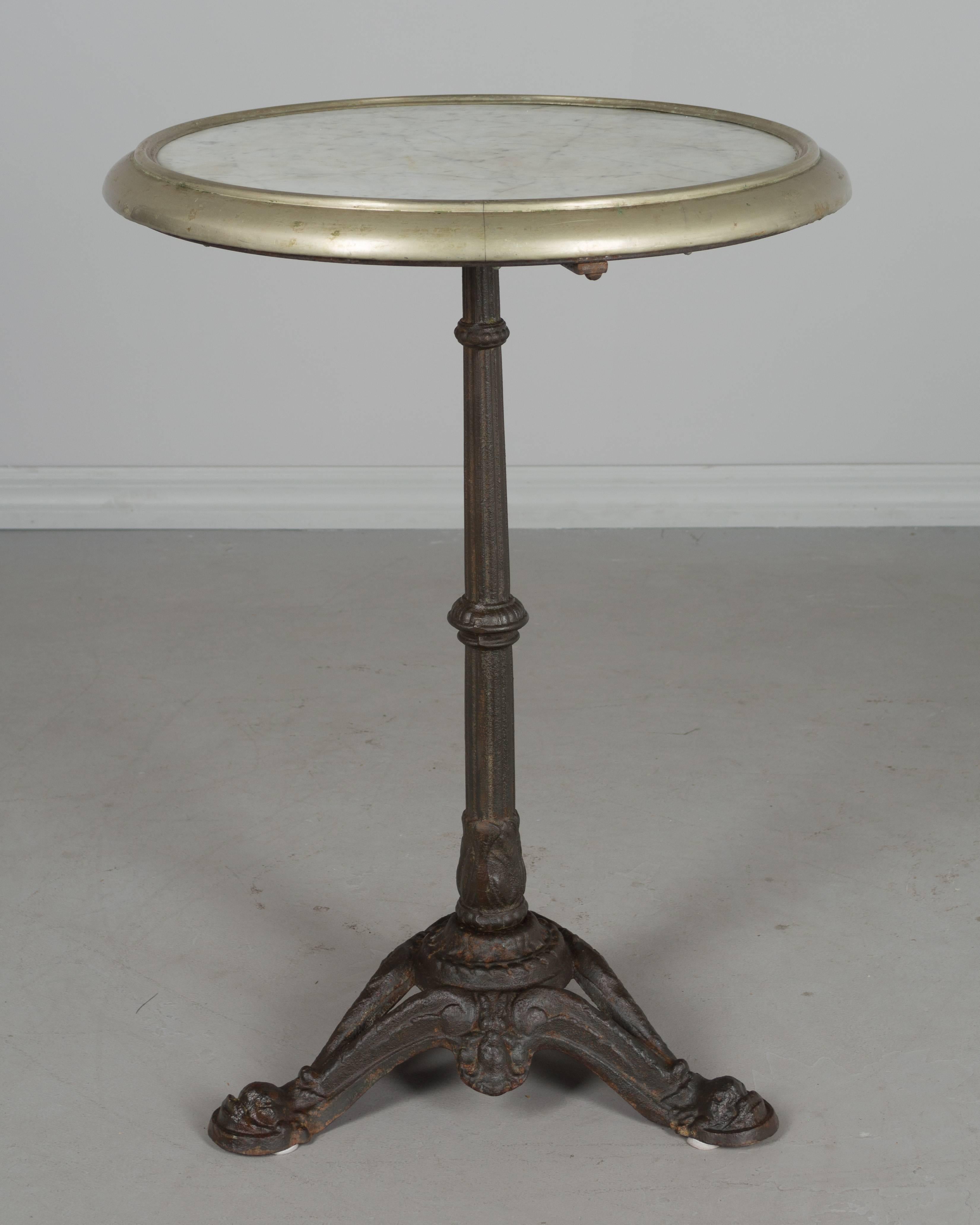 A 19th century French cast iron bistro table with beautiful warm patina. Original white marble top with brass rim. Very well made and in excellent condition. Weight: 41lbs.
More photos available upon request. We have a large selection of French