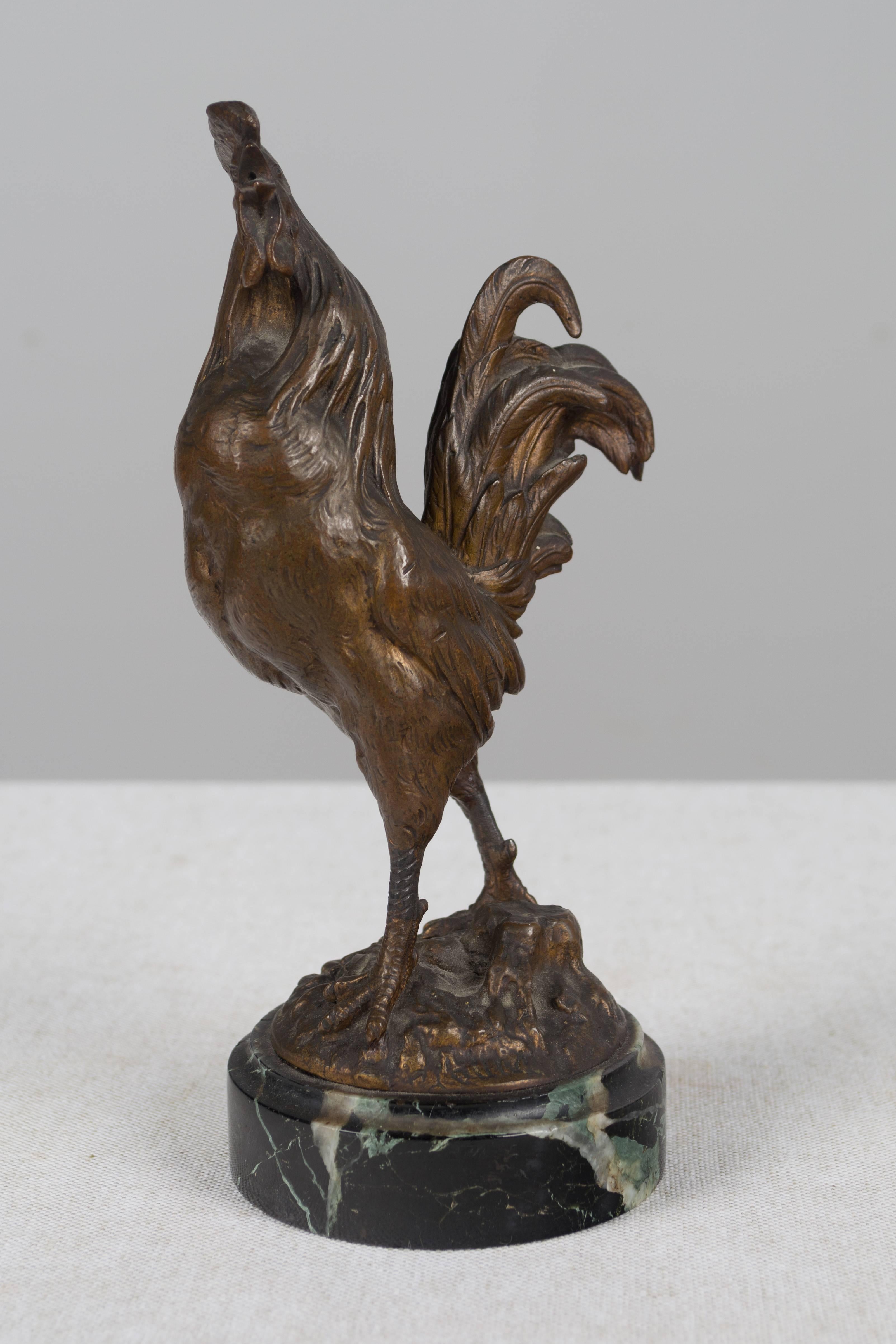 A small 19th century French cast bronze rooster on a marble base by Charles Paillet (1871-1931), a sculptor whose main emphasis was animals subjects. Signed C. Paillet. Weight 2.6 lbs. More photos available upon request. We have a large selection of